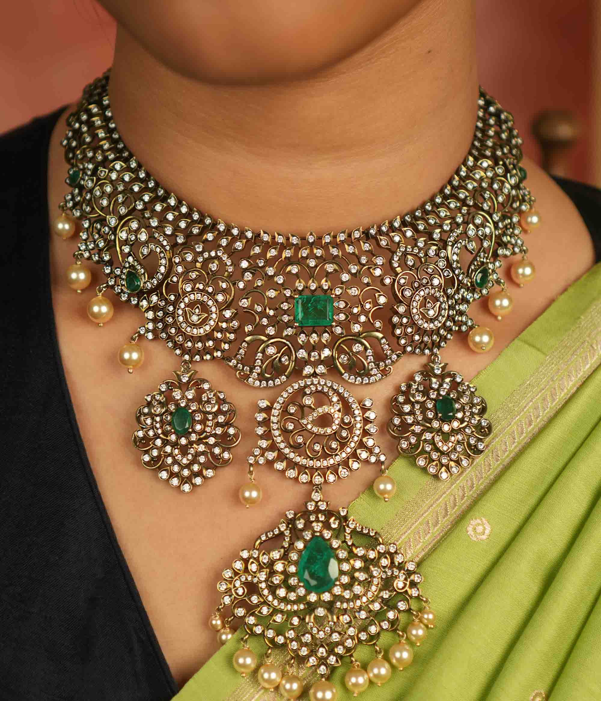 Victorian elegance reborn! This moissanite necklace with floral patterns, green-cut stones, CZ brilliance, and pearl droplets whispers timeless opulence.