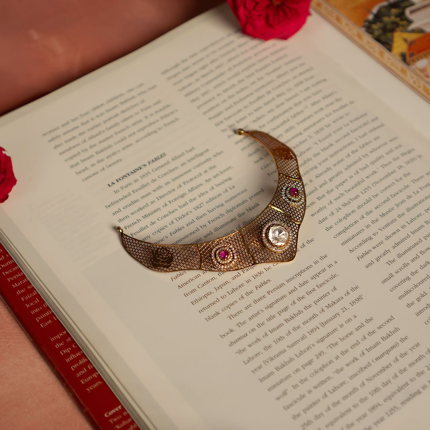 Elegant gold-plated silver choker featuring an intricate mesh design adorned with dazzling CZ stones, Polki stones, and vibrant red cut stones. The structured silhouette showcases a central Polki stone surrounded by fine detailing, complemented by red cut stones on either side, adding a regal touch. The fusion of textures and embellishments exudes a luxurious, vintage charm, making it a perfect statement piece.