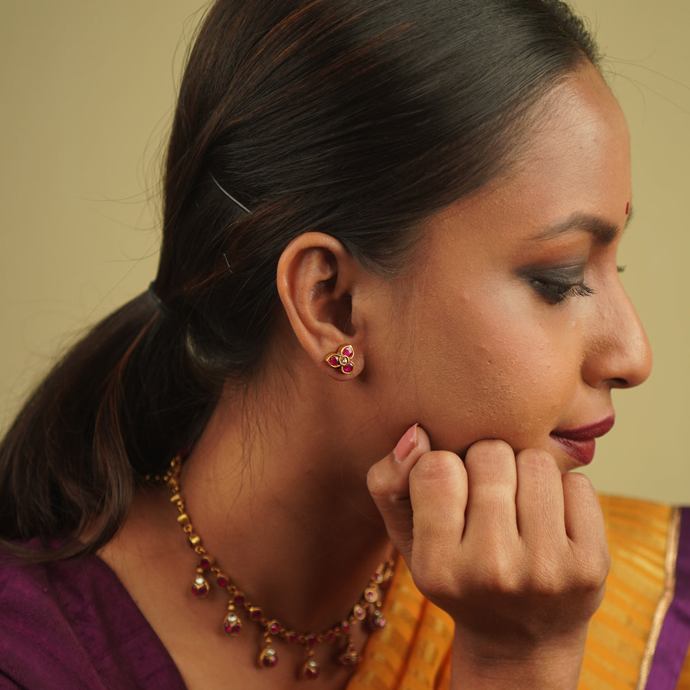 Timila Studs: A perfect blend of vintage charm and modern elegance, featuring delicate red and green kundan florals set in gold-plated silver.