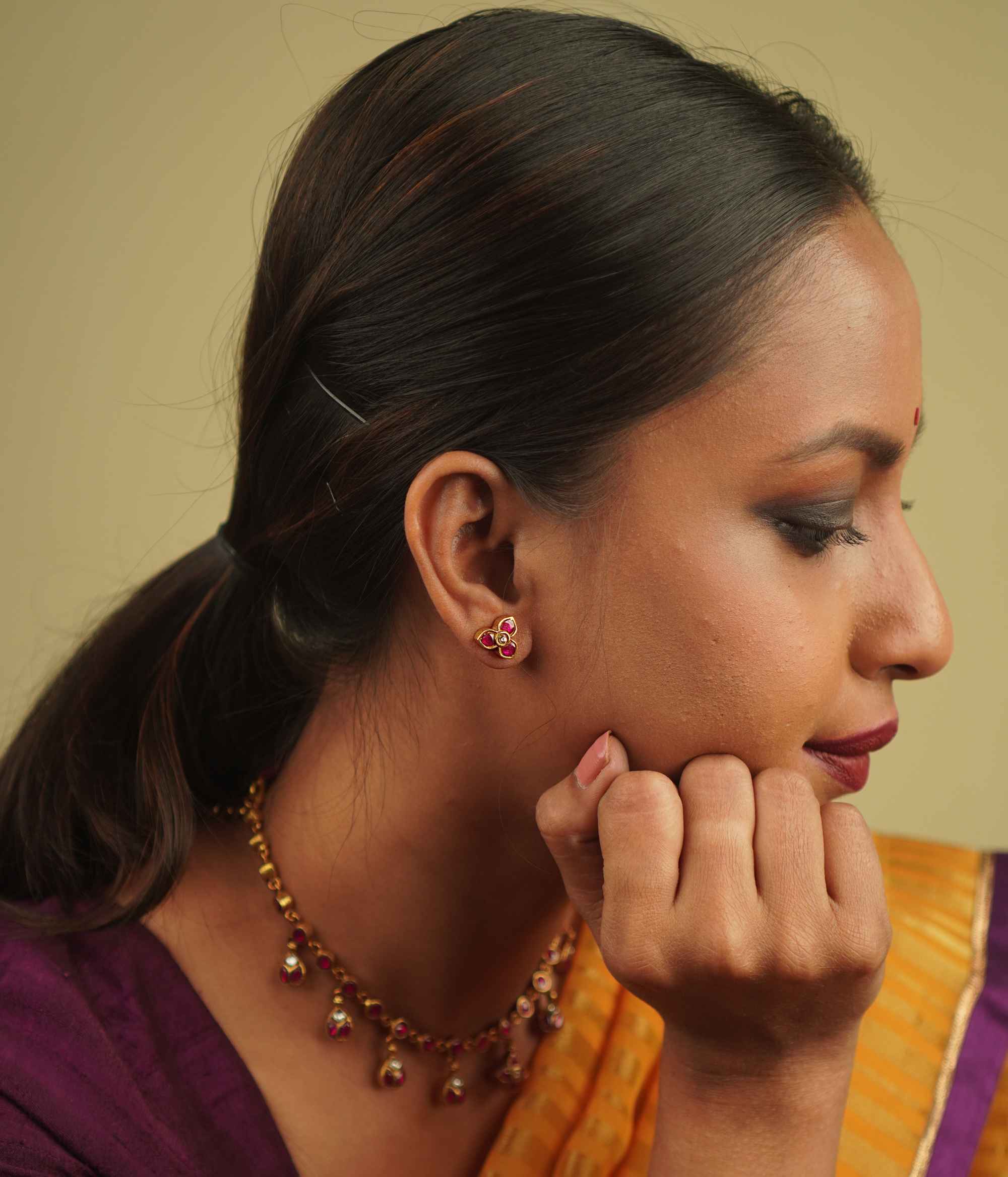 Timila Studs: A perfect blend of vintage charm and modern elegance, featuring delicate red and green kundan florals set in gold-plated silver.