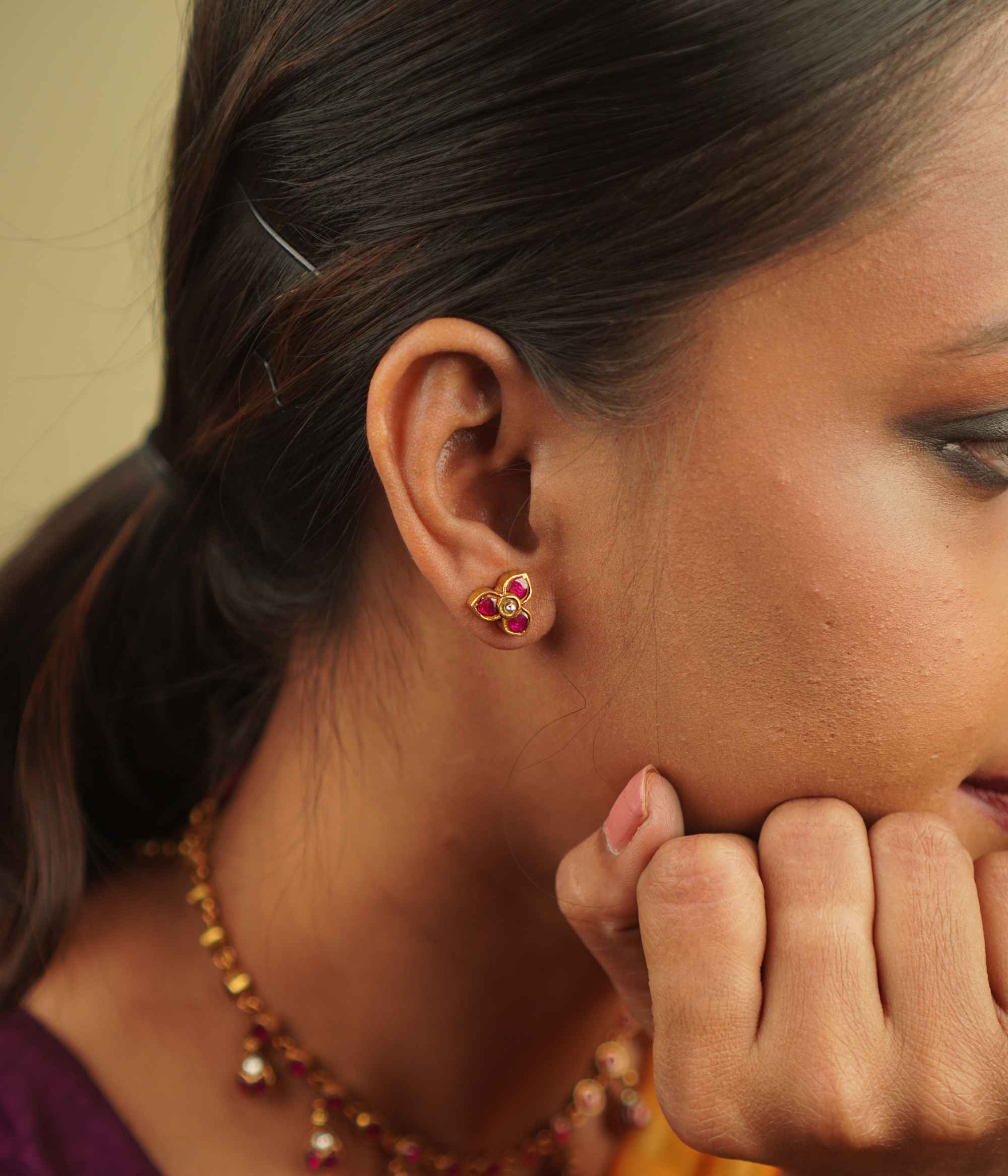 Timila Studs: A perfect blend of vintage charm and modern elegance, featuring delicate red and green kundan florals set in gold-plated silver.