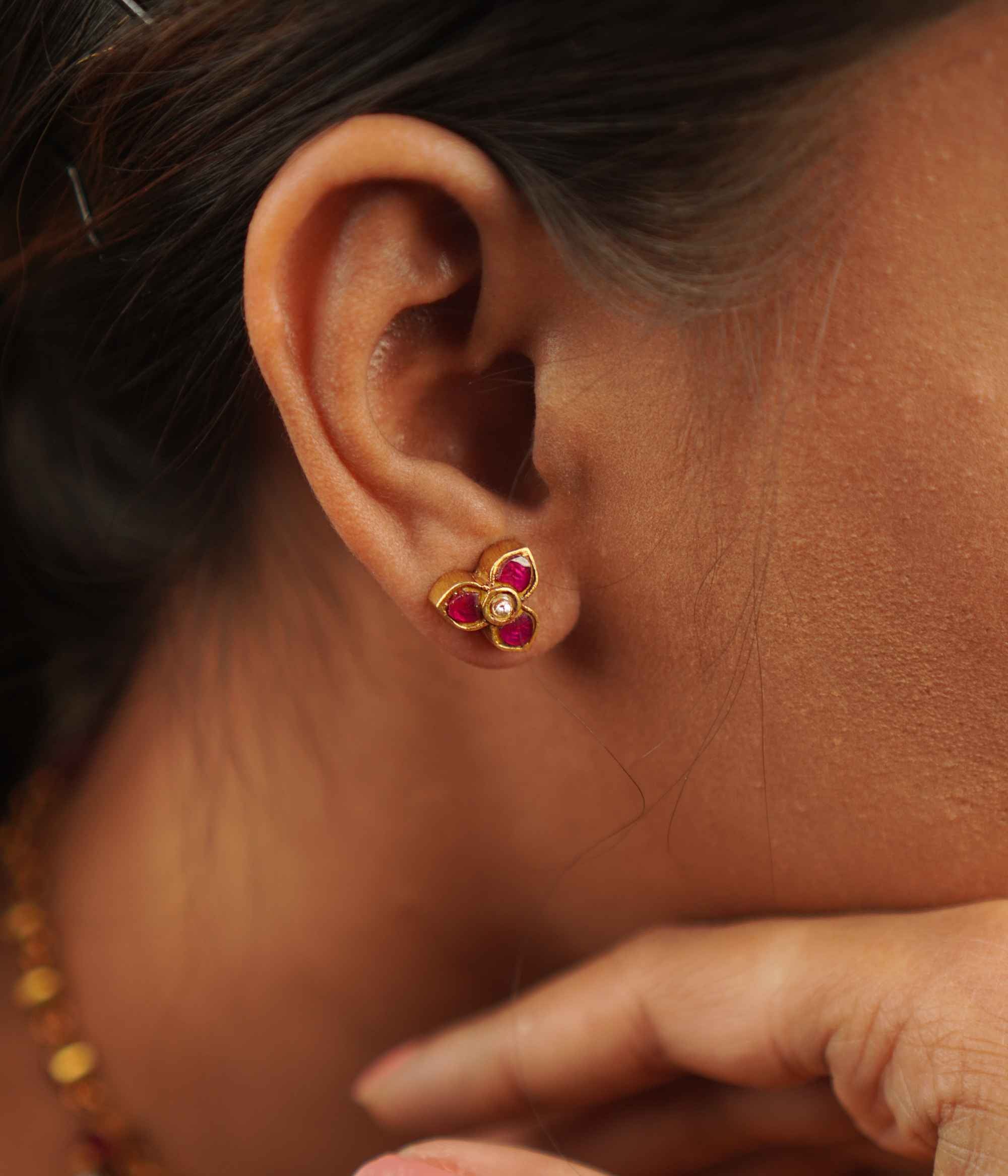 Timila Studs: A perfect blend of vintage charm and modern elegance, featuring delicate red and green kundan florals set in gold-plated silver.