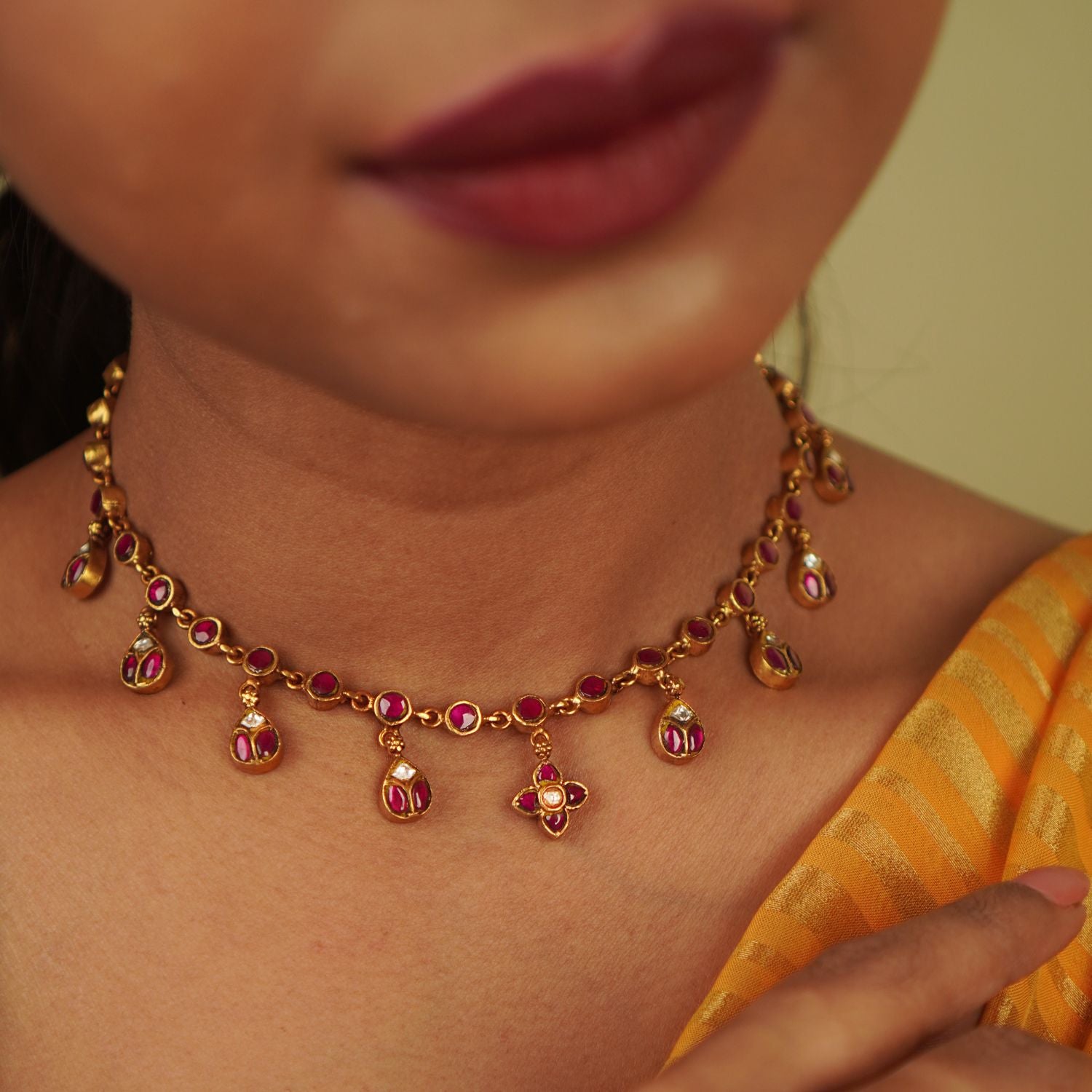 Timila Necklace: A blend of minimalism and vintage charm, this gold-plated silver piece features red Kundan, diamonds, and delicate floral motif droplets, creating a timeless elegance.