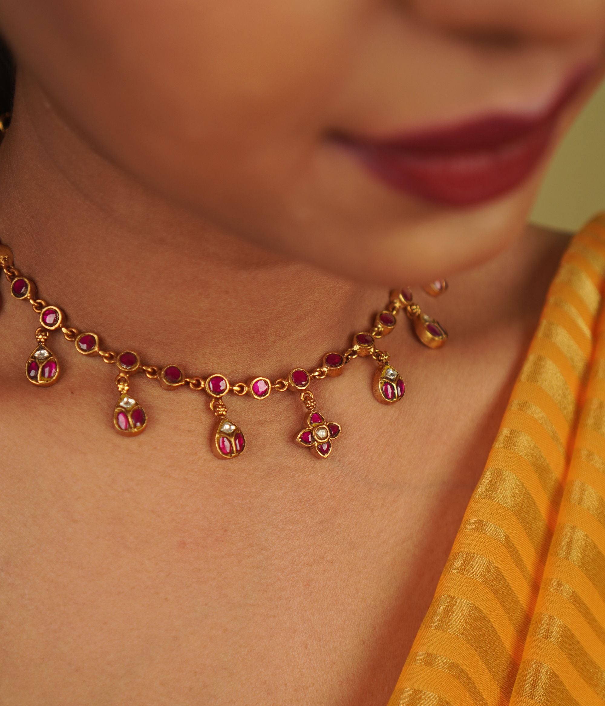 Timila Necklace: A blend of minimalism and vintage charm, this gold-plated silver piece features red Kundan, diamonds, and delicate floral motif droplets, creating a timeless elegance.