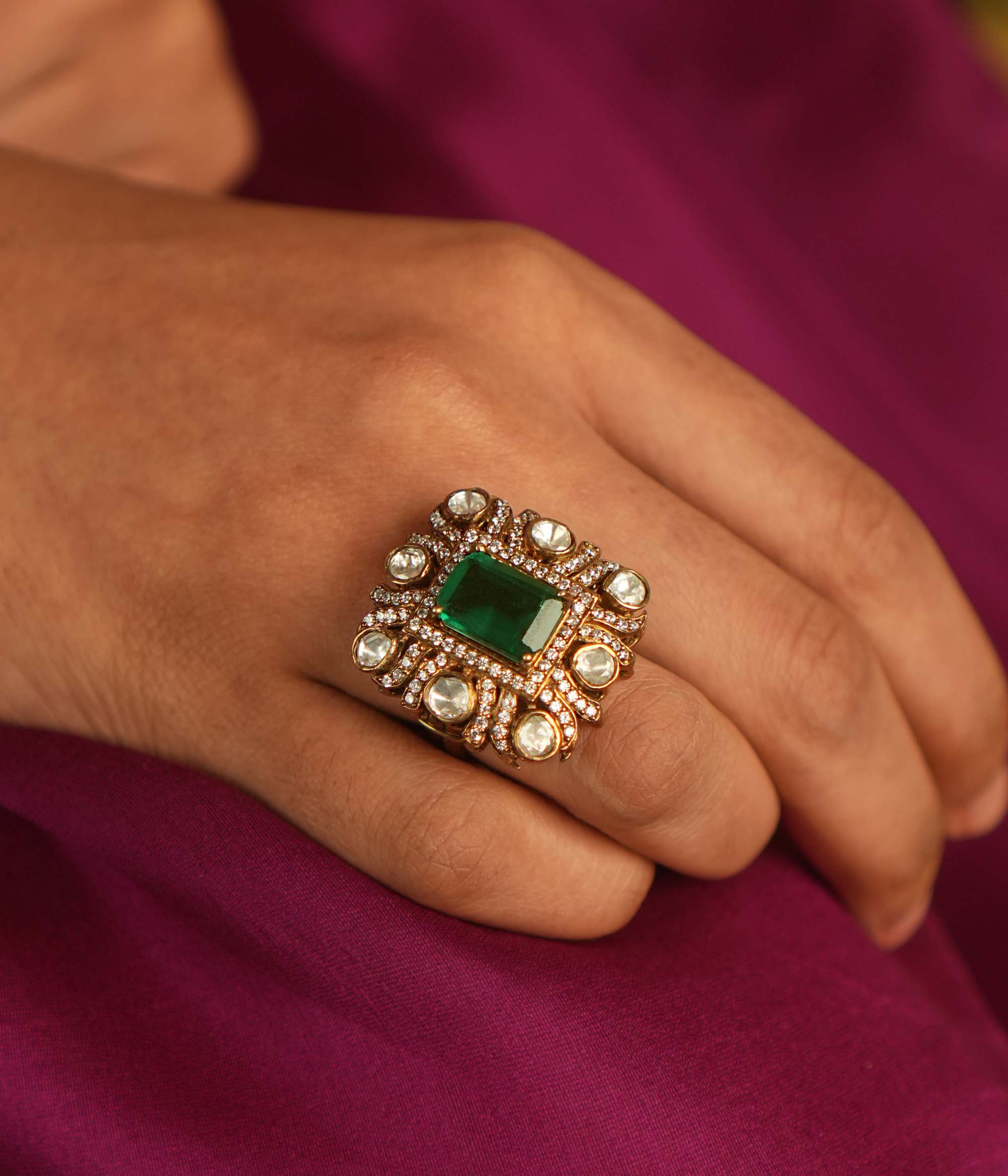Geometric elegance reborn! A square emerald ring, framed by Moissanite and Polki, blends modern sophistication with timeless charm.