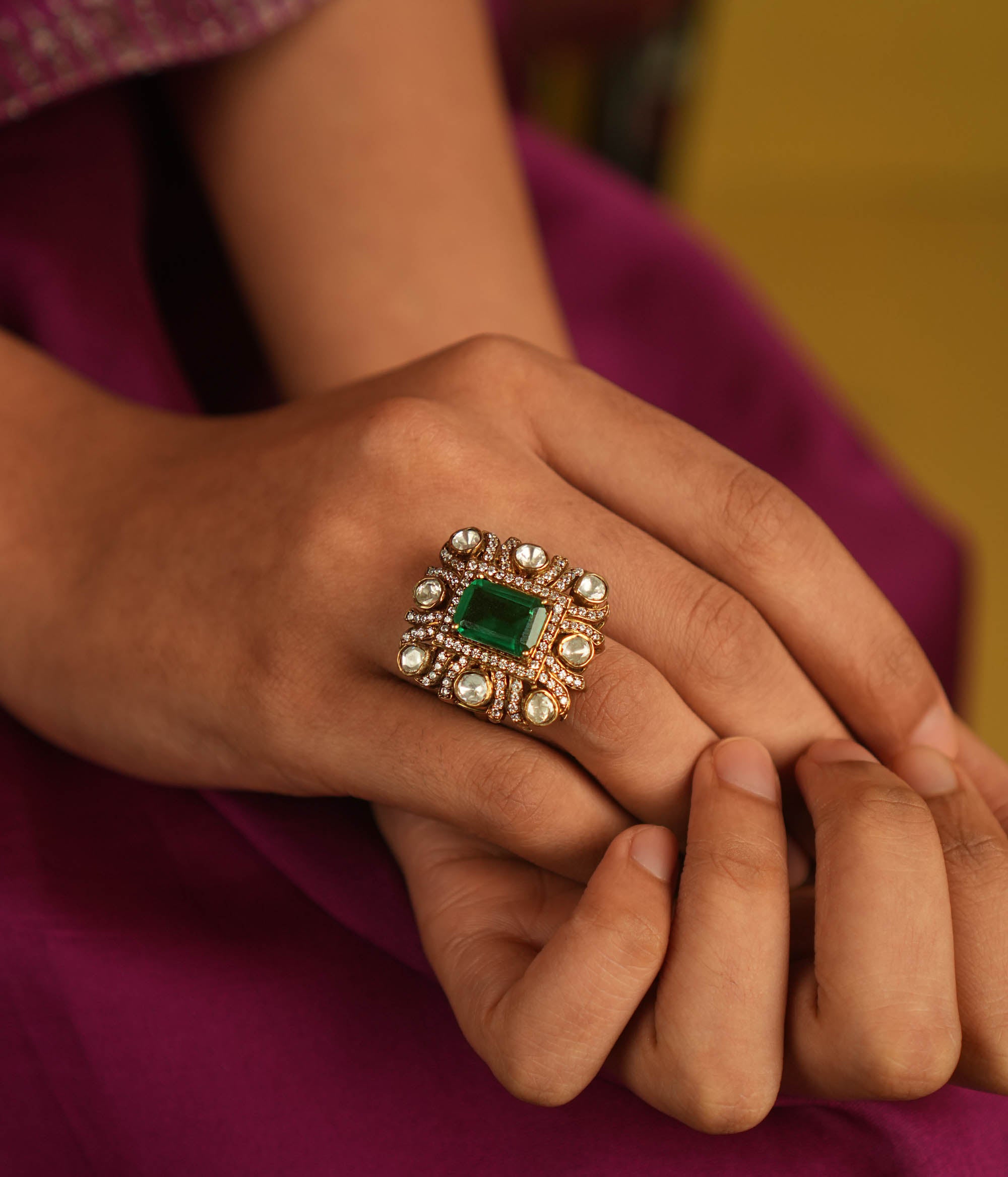 Geometric elegance reborn! A square emerald ring, framed by Moissanite and Polki, blends modern sophistication with timeless charm.