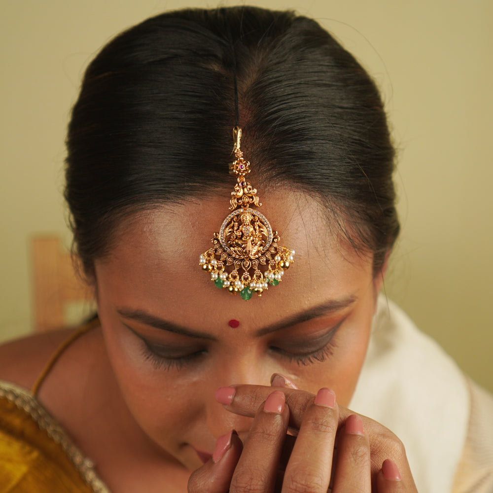 Tulsi Maangtika: Gold-plated silver with a goddess motif, embellished with moissanite and pearls. A perfect blend of vintage charm and contemporary sophistication, bringing heritage into the modern world.