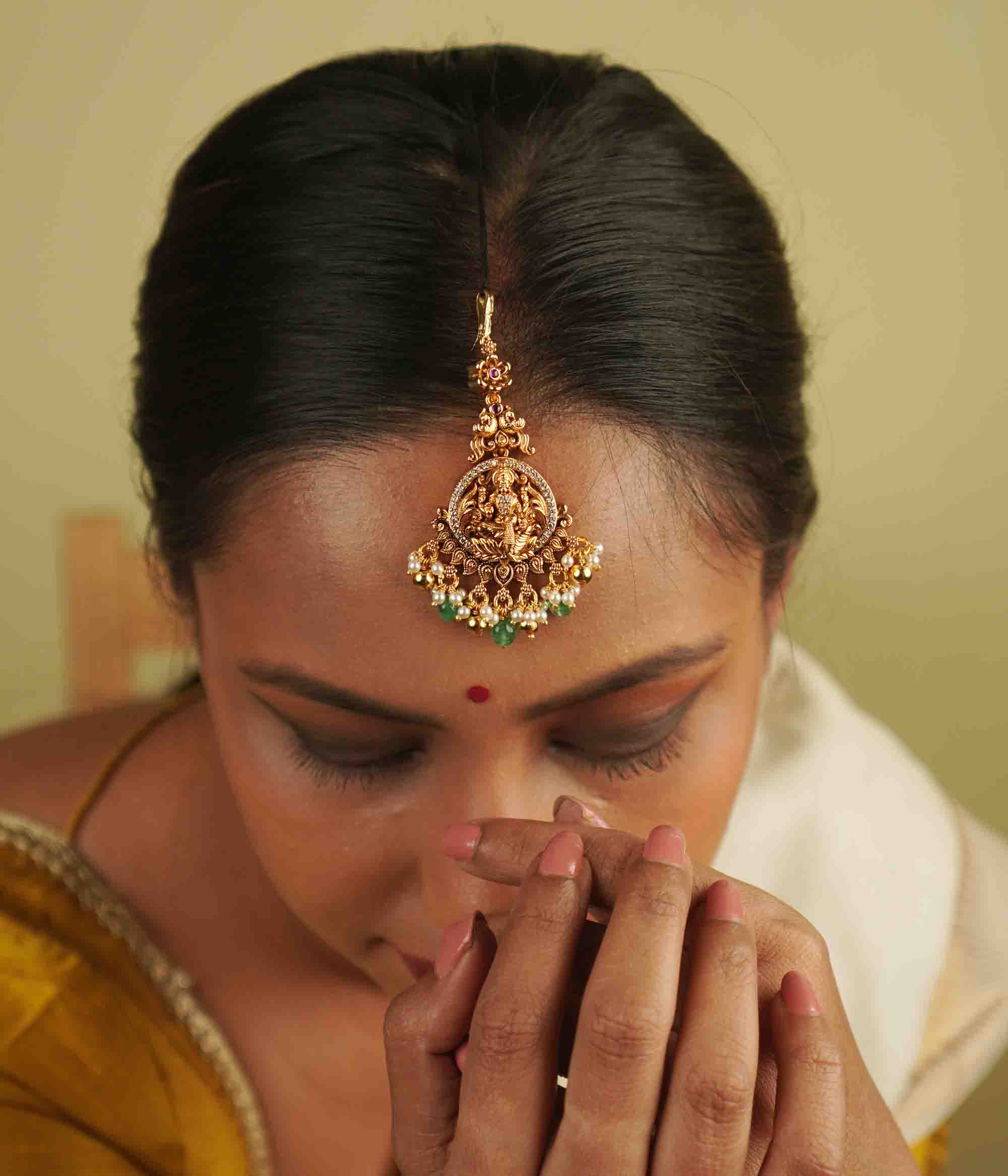 Tulsi Maangtika: Gold-plated silver with a goddess motif, embellished with moissanite and pearls. A perfect blend of vintage charm and contemporary sophistication, bringing heritage into the modern world.
