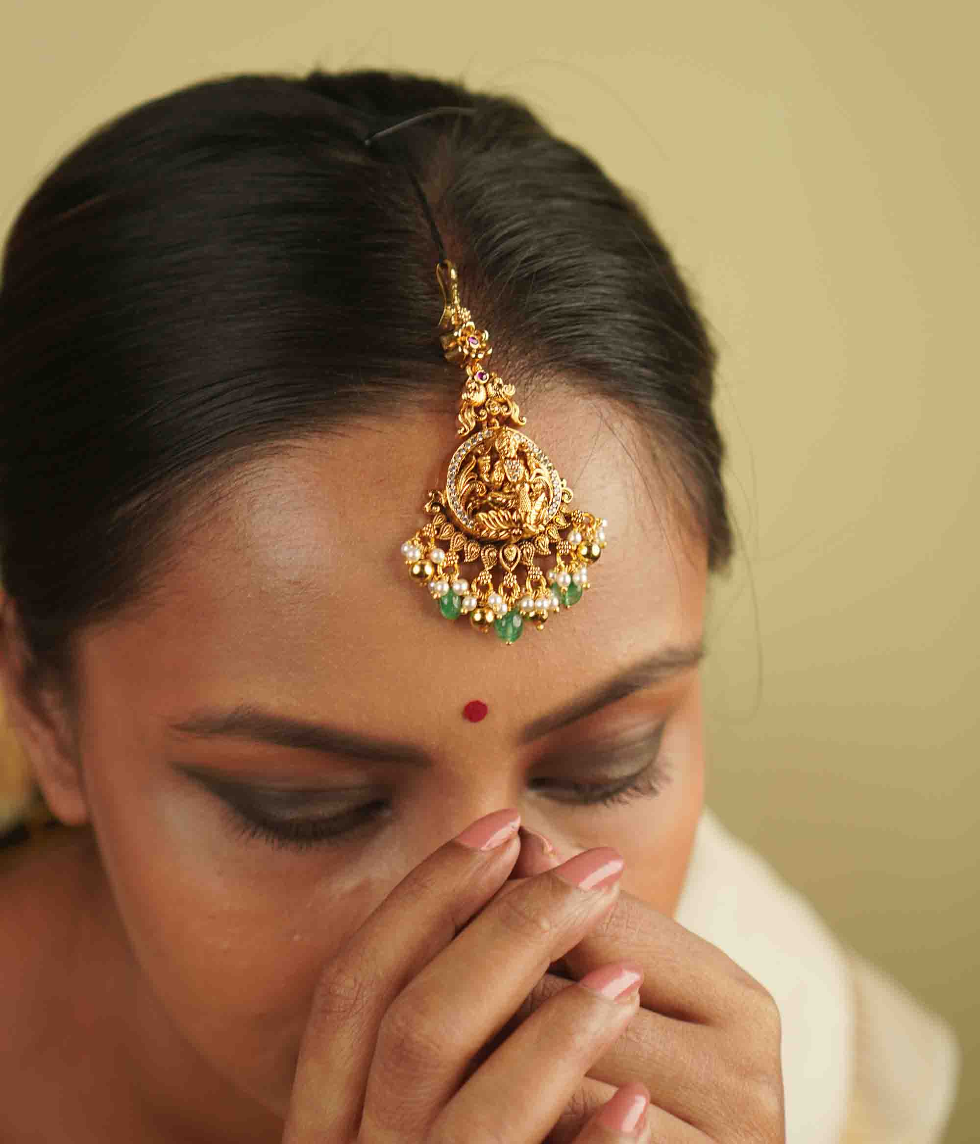 Tulsi Maangtika: Gold-plated silver with a goddess motif, embellished with moissanite and pearls. A perfect blend of vintage charm and contemporary sophistication, bringing heritage into the modern world.
