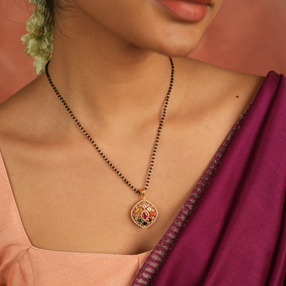 Celestial whispers reimagined. A geometric Navratna and moissanite pendant where ancient wisdom seamlessly meets modern elegance, radiating cosmic harmony.
