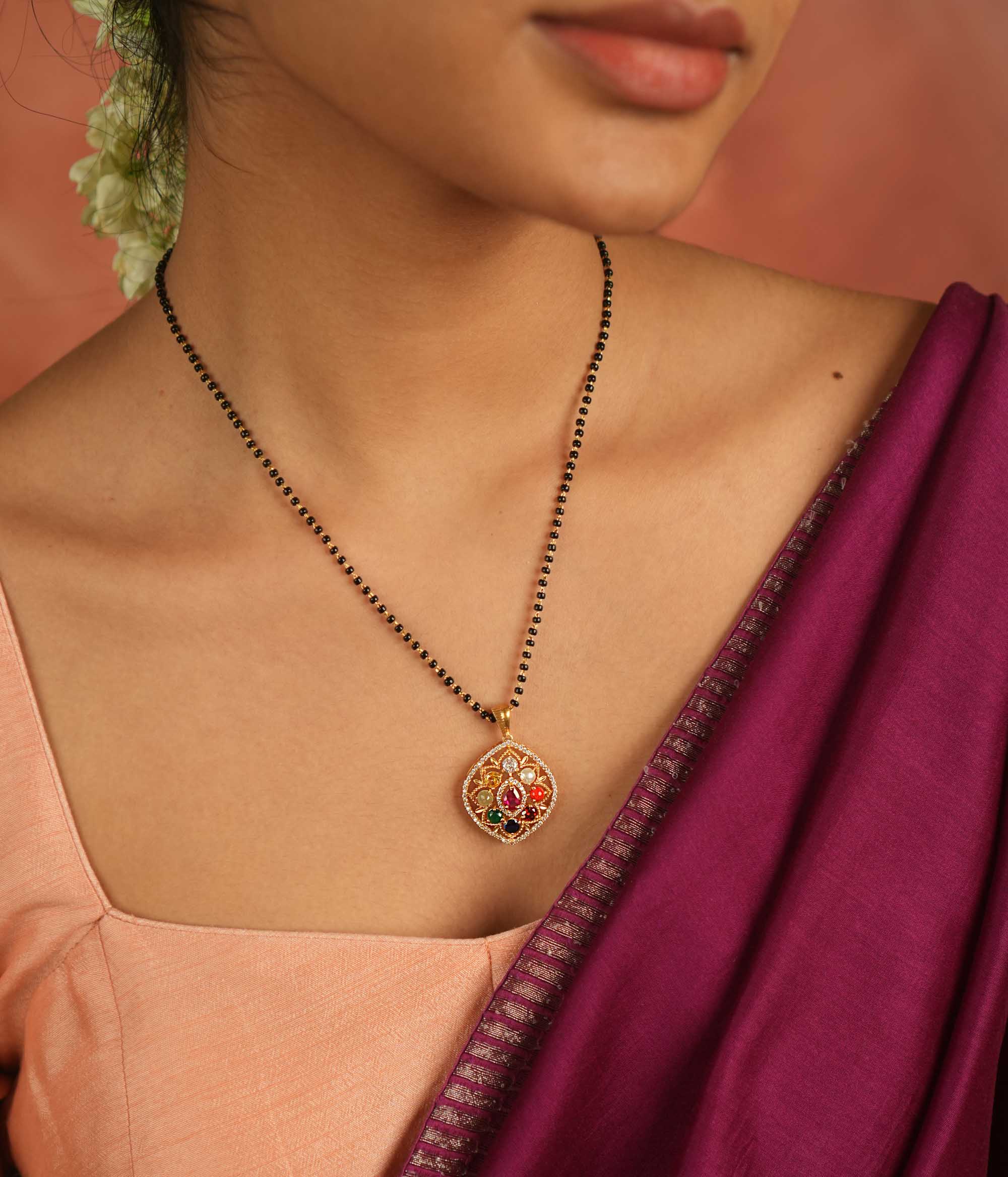 Celestial whispers reimagined. A geometric Navratna and moissanite pendant where ancient wisdom seamlessly meets modern elegance, radiating cosmic harmony.