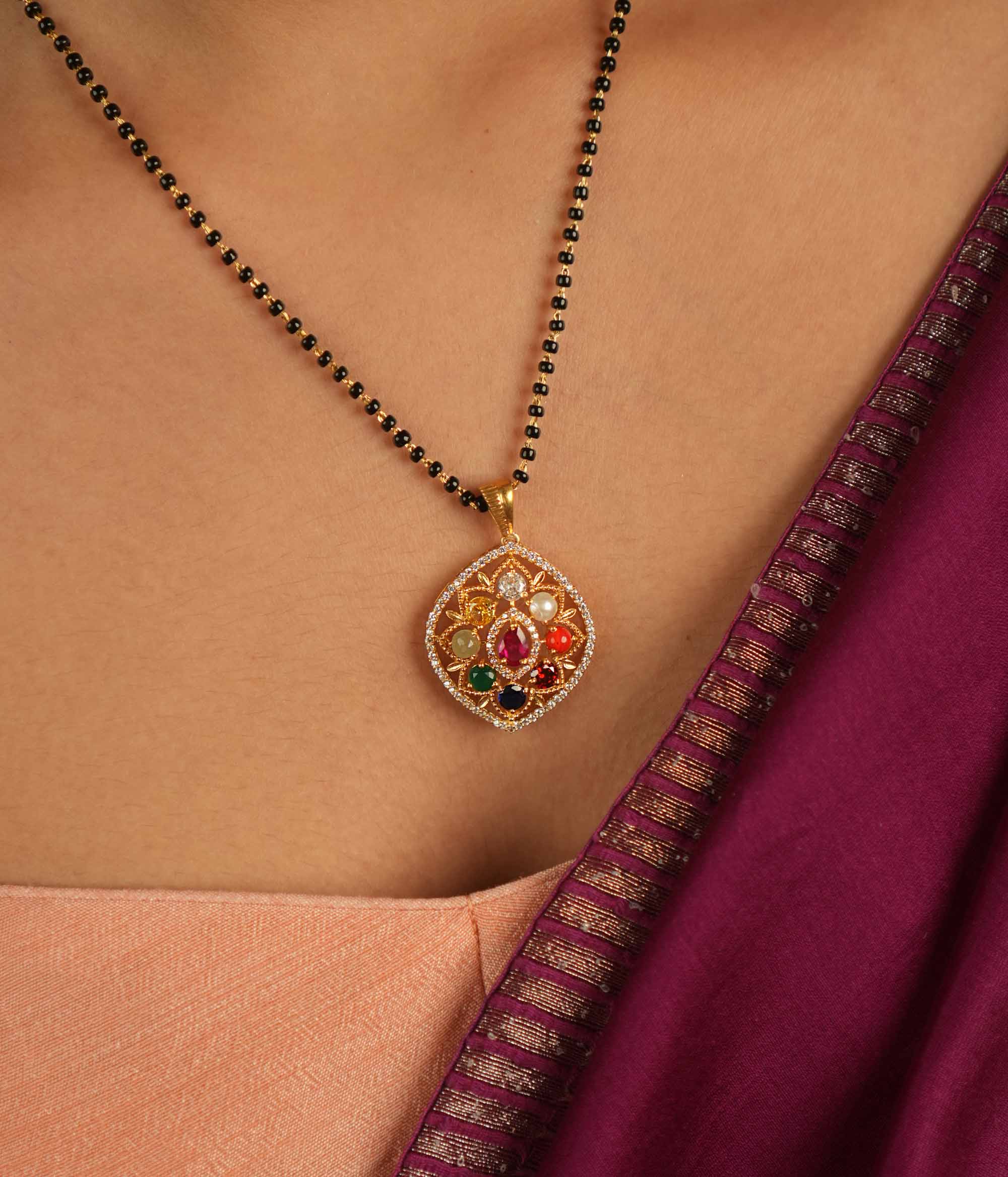 Celestial whispers reimagined. A geometric Navratna and moissanite pendant where ancient wisdom seamlessly meets modern elegance, radiating cosmic harmony.