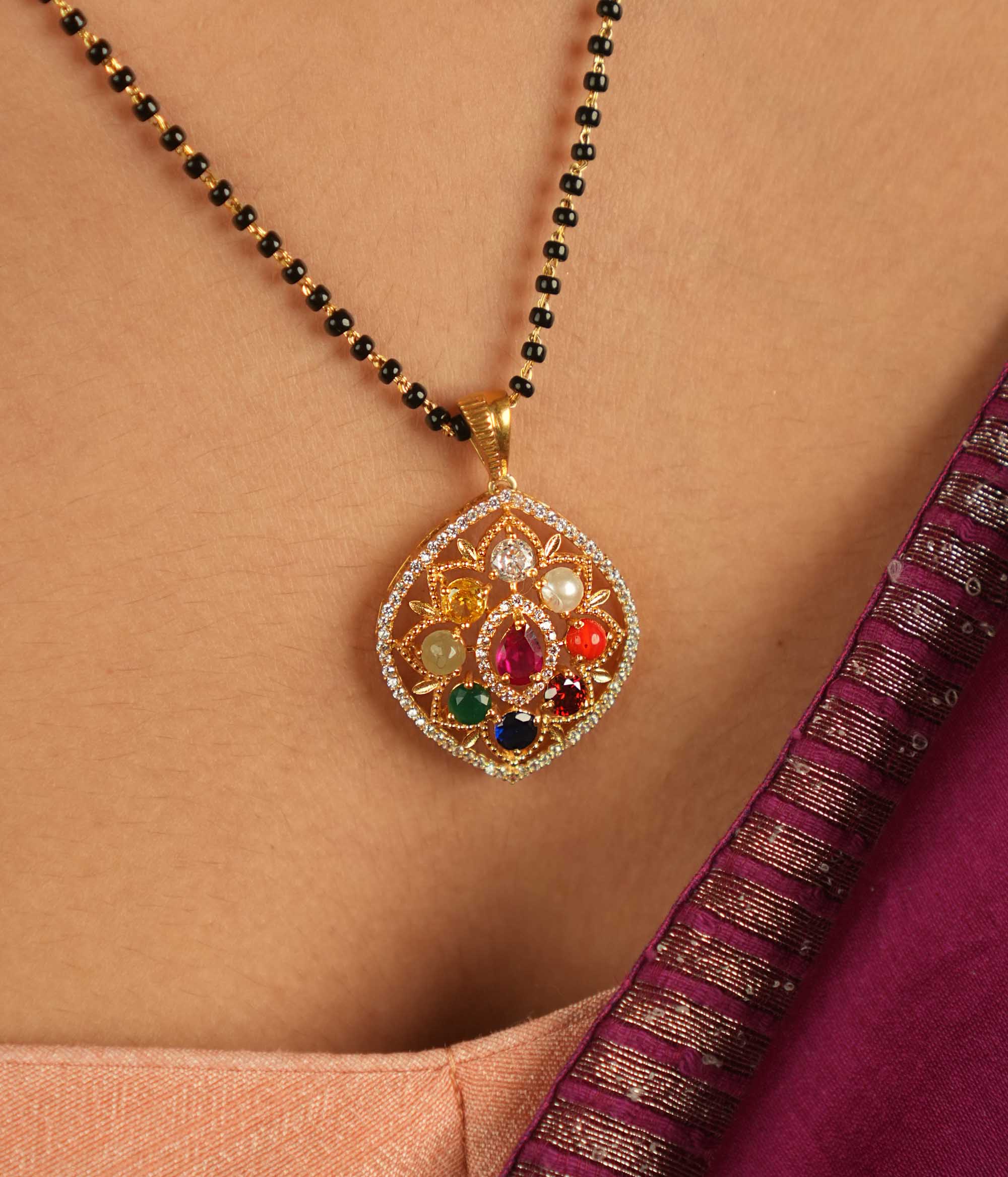 Celestial whispers reimagined. A geometric Navratna and moissanite pendant where ancient wisdom seamlessly meets modern elegance, radiating cosmic harmony.