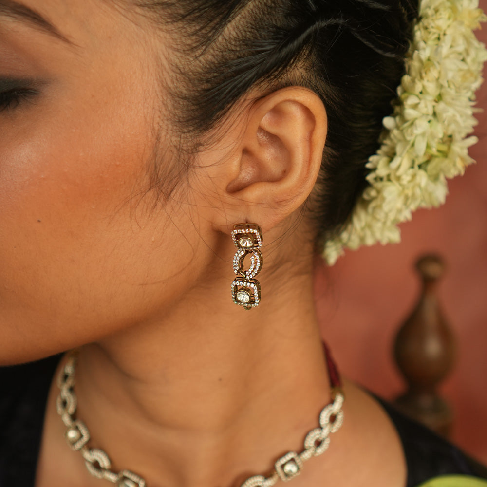 Geometric whispers reborn! Polki and CZ drop earrings shimmer with modern elegance, offering timeless luxury for the minimalist connoisseur.