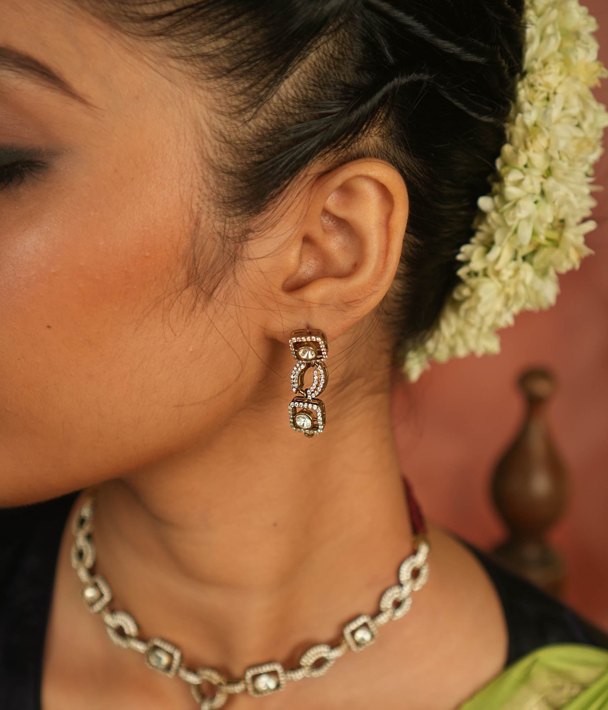 Geometric whispers reborn! Polki and CZ drop earrings shimmer with modern elegance, offering timeless luxury for the minimalist connoisseur.