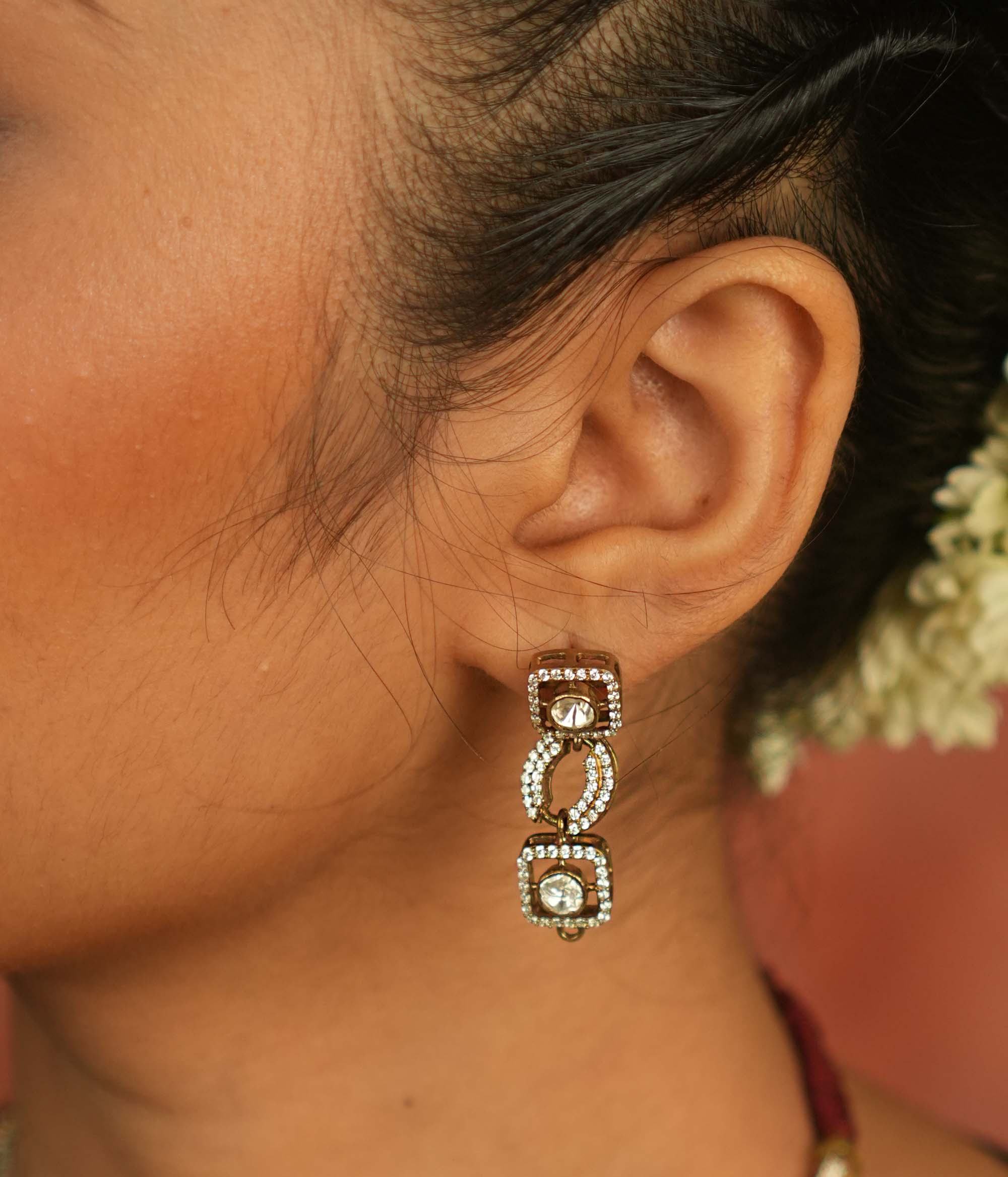 Geometric whispers reborn! Polki and CZ drop earrings shimmer with modern elegance, offering timeless luxury for the minimalist connoisseur.