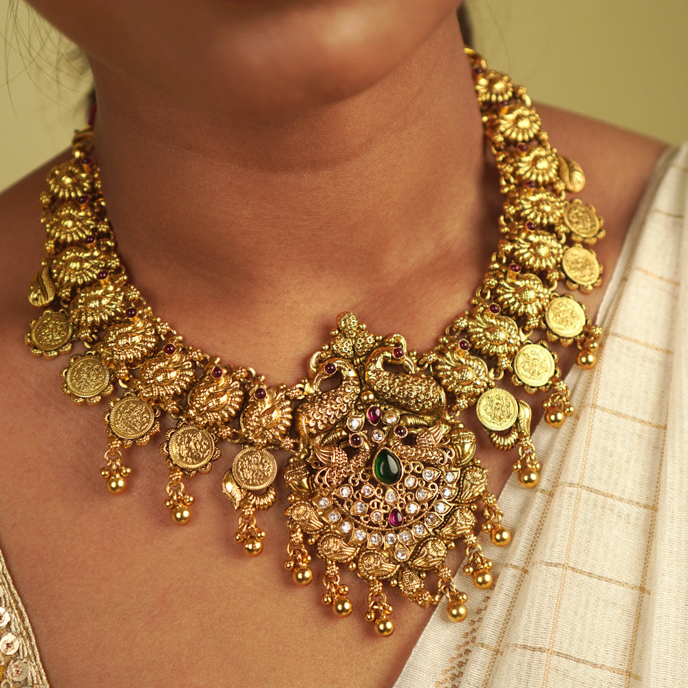 Revival Necklace: Reimagining India's rich heritage, this stunning piece features peacock motifs, red and green spinel stones, and white cut stones, blending gold-plated silver with moissanite and kundans. A vibrant tribute to the land of colors and tradition.