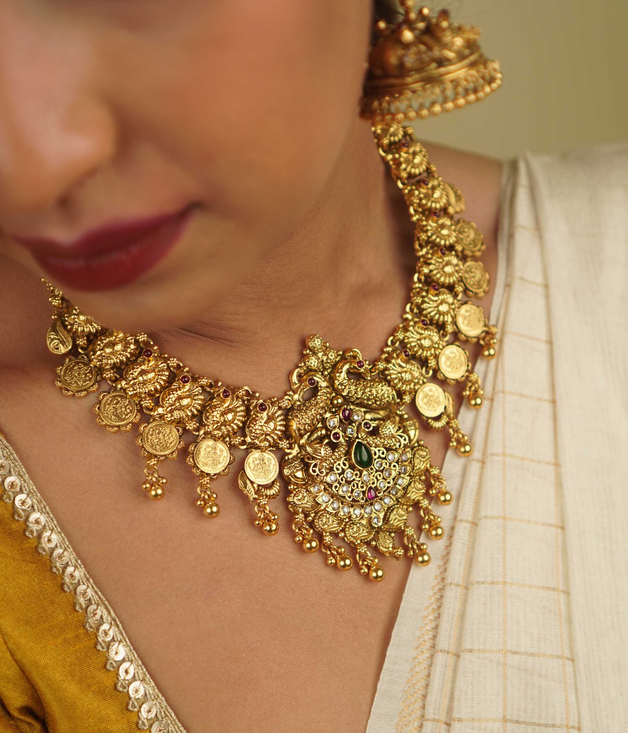 Revival Necklace: Reimagining India's rich heritage, this stunning piece features peacock motifs, red and green spinel stones, and white cut stones, blending gold-plated silver with moissanite and kundans. A vibrant tribute to the land of colors and tradition.
