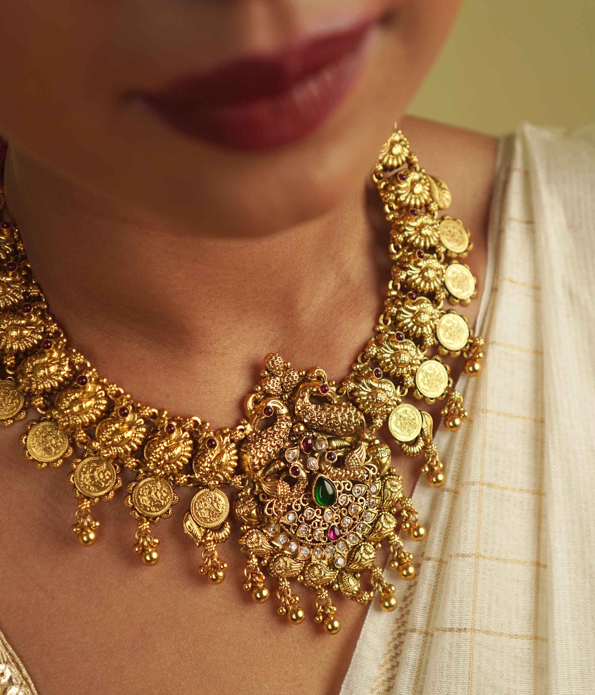 Revival Necklace: Reimagining India's rich heritage, this stunning piece features peacock motifs, red and green spinel stones, and white cut stones, blending gold-plated silver with moissanite and kundans. A vibrant tribute to the land of colors and tradition.