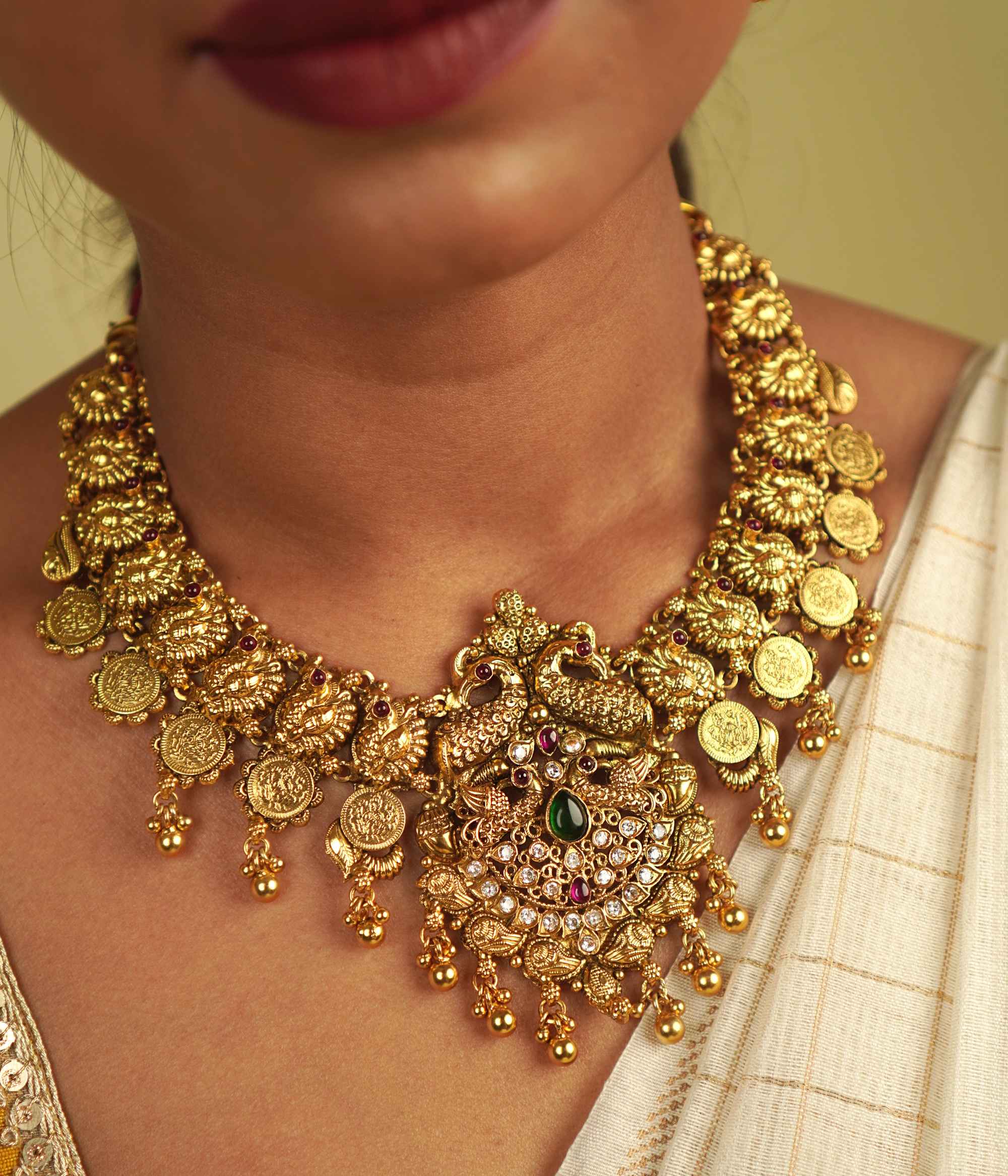 Revival Necklace: Reimagining India's rich heritage, this stunning piece features peacock motifs, red and green spinel stones, and white cut stones, blending gold-plated silver with moissanite and kundans. A vibrant tribute to the land of colors and tradition.