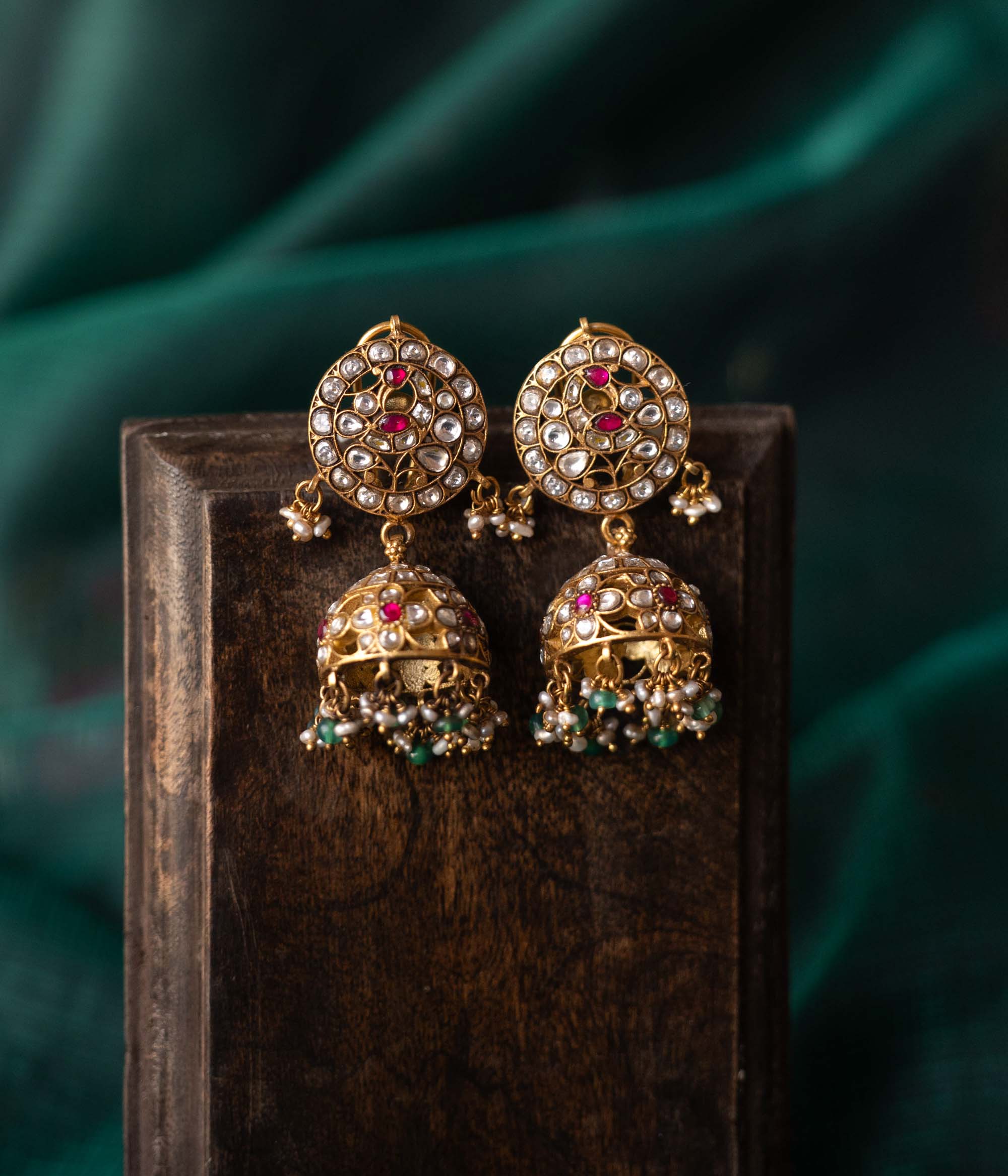 Bridal kundan silver jhumkas with red and green stones
