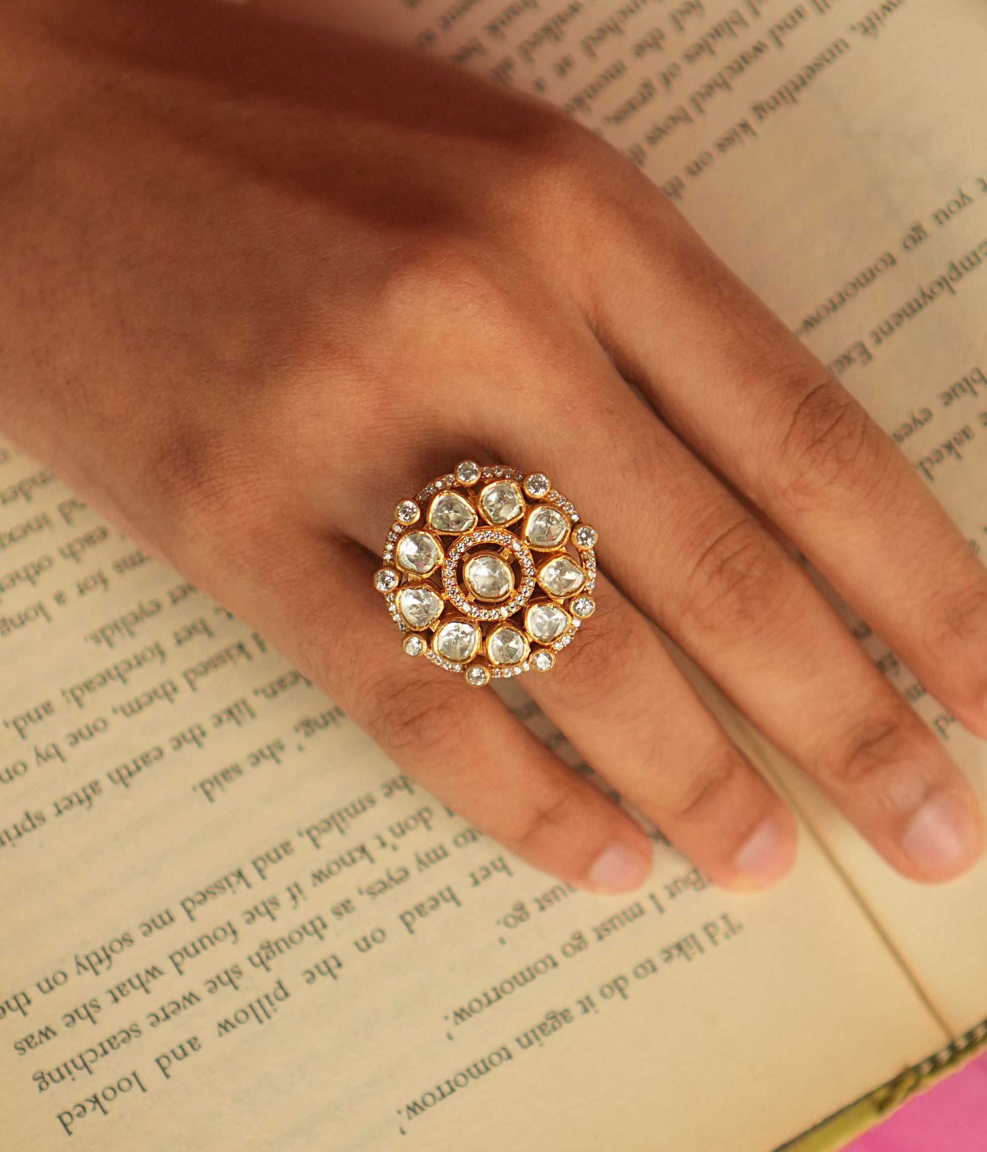 In a realm of opulence, this minimalist floral ring shines with the delicate beauty of Polki stones and the sparkle of shimmering Moissanite, creating a refined yet extravagant piece.