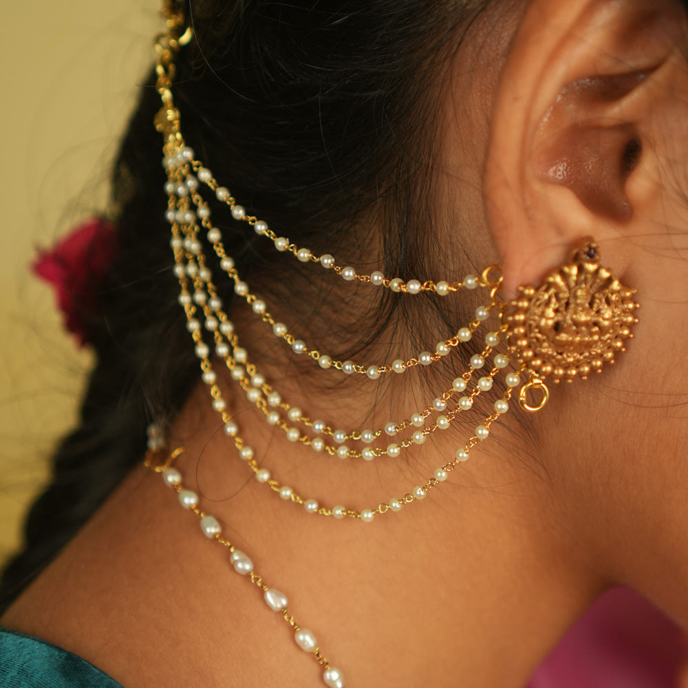 Ethereal grace reborn! This delicate gold-plated pearl ear chain exudes timeless elegance, with lustrous pearls linked in a graceful flow. A blend of heritage and sophistication, it beautifully complements any traditional or modern ensemble, making it a treasured adornment for every occasion.