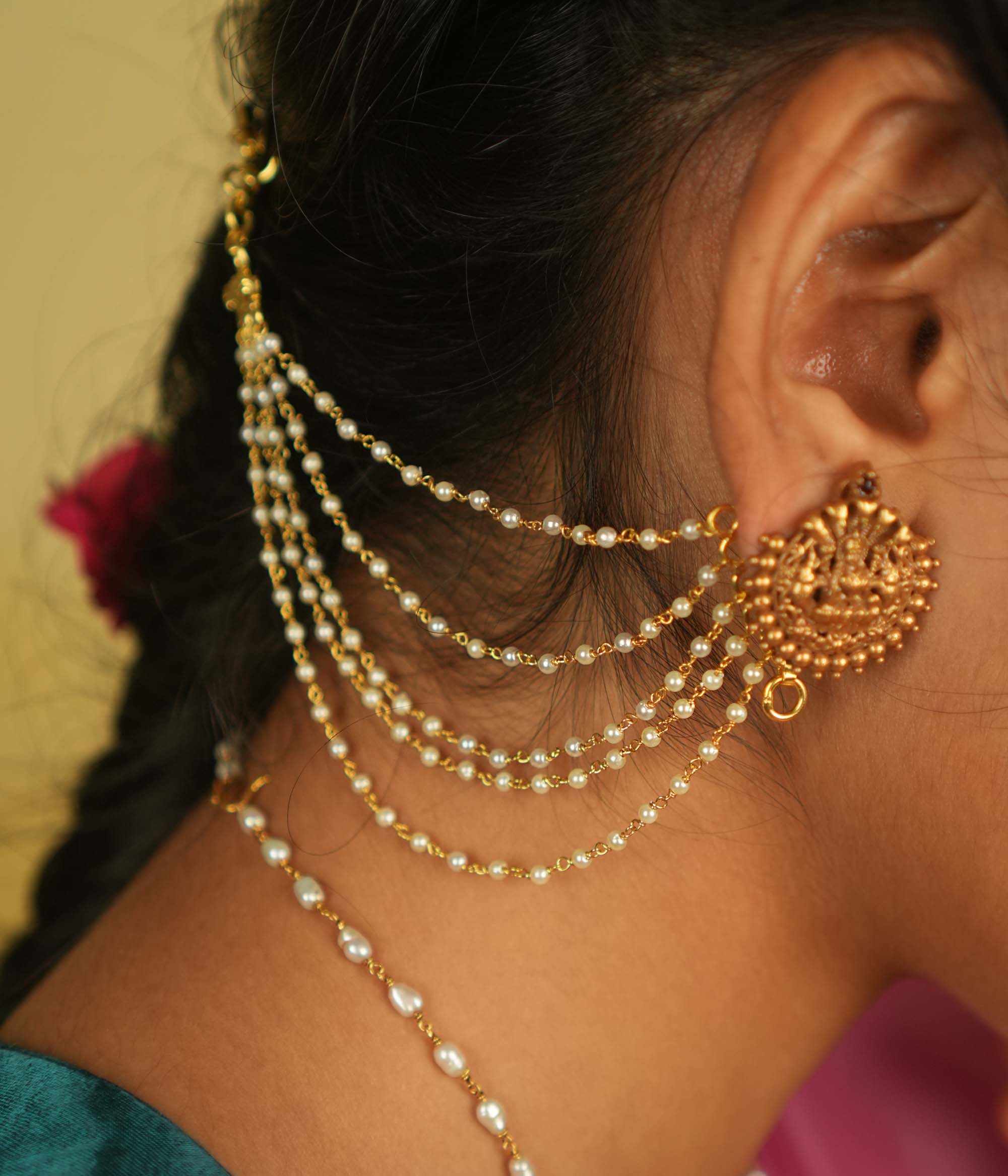 Ethereal grace reborn! This delicate gold-plated pearl ear chain exudes timeless elegance, with lustrous pearls linked in a graceful flow. A blend of heritage and sophistication, it beautifully complements any traditional or modern ensemble, making it a treasured adornment for every occasion.