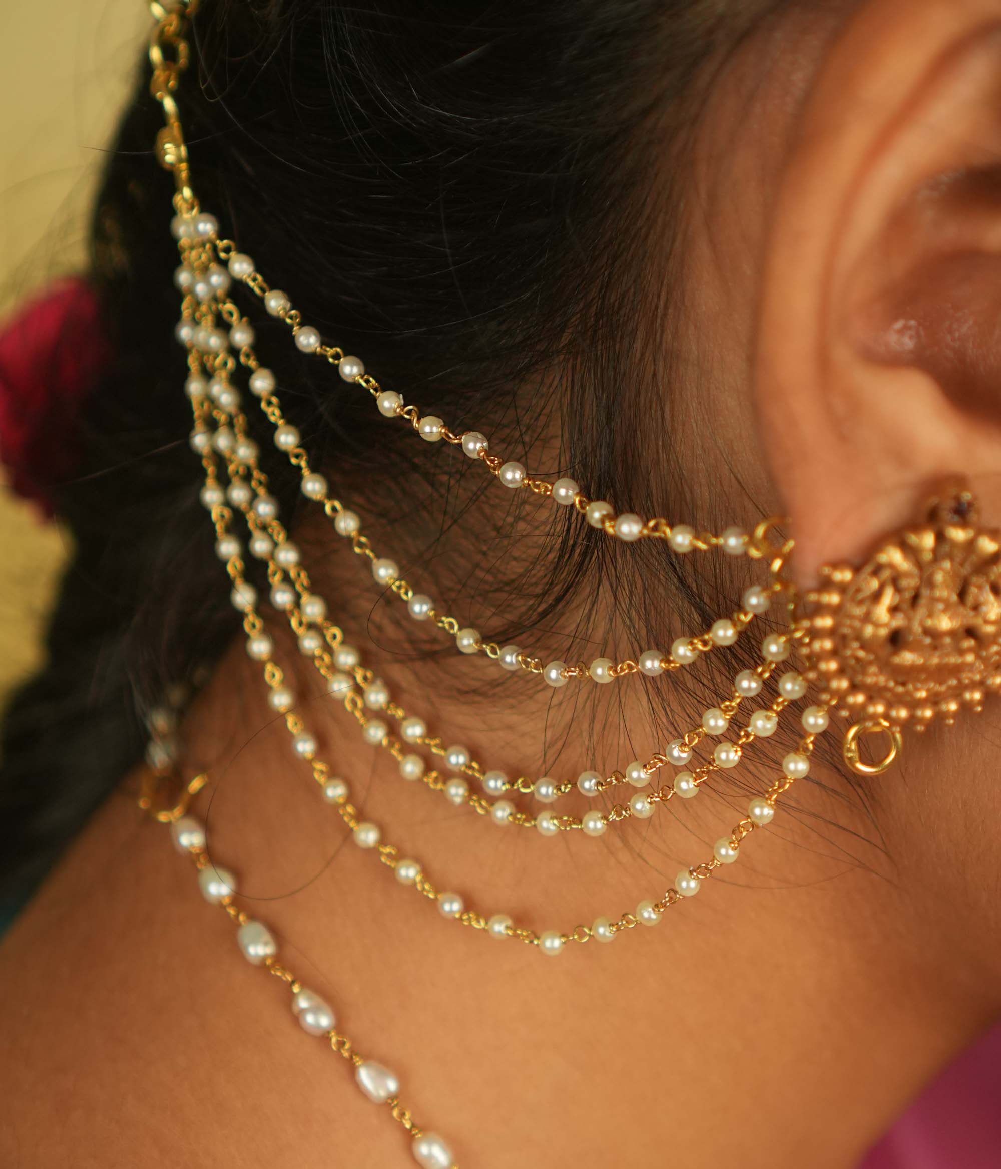 Ethereal grace reborn! This delicate gold-plated pearl ear chain exudes timeless elegance, with lustrous pearls linked in a graceful flow. A blend of heritage and sophistication, it beautifully complements any traditional or modern ensemble, making it a treasured adornment for every occasion.