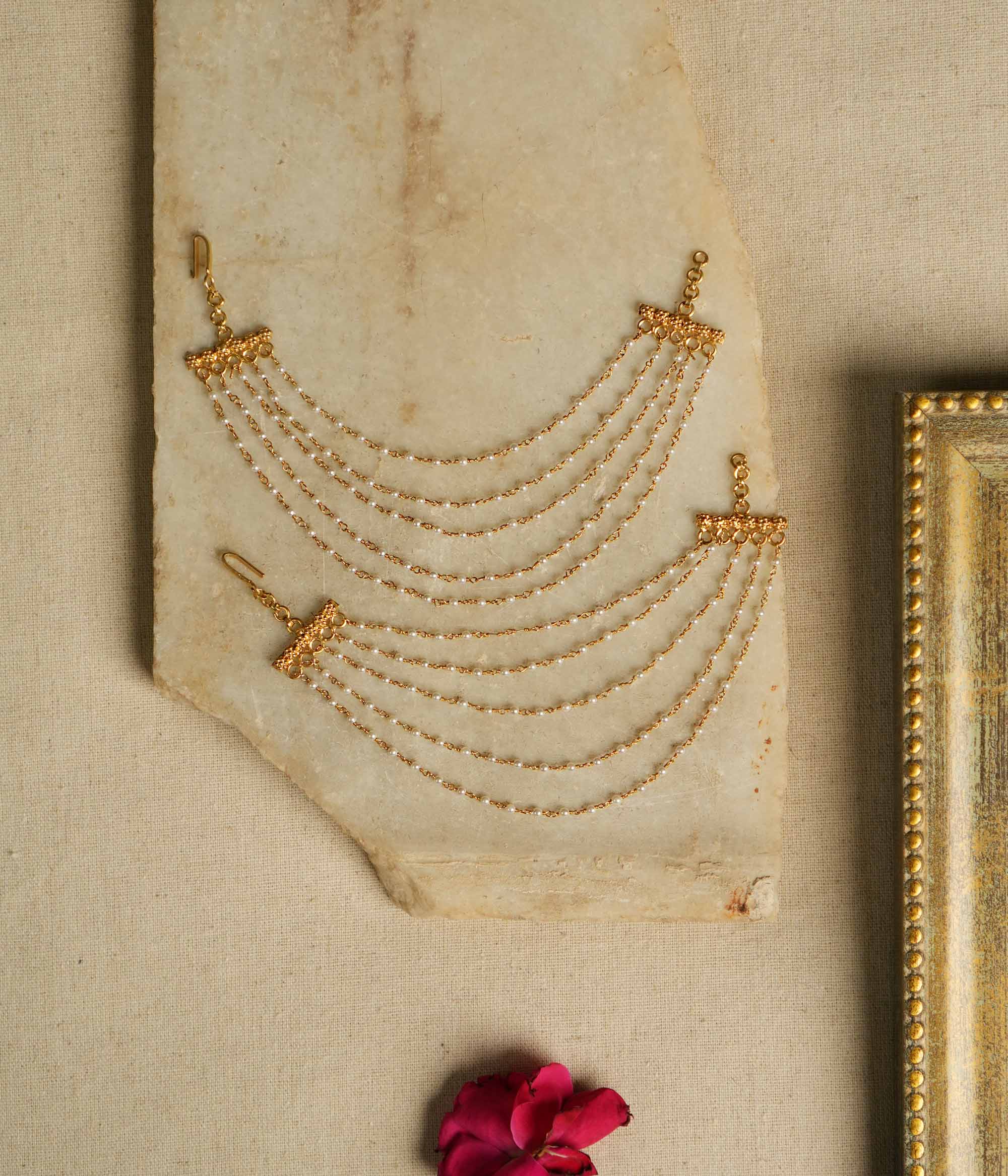 Ethereal grace reborn! This delicate gold-plated pearl ear chain exudes timeless elegance, with lustrous pearls linked in a graceful flow. A blend of heritage and sophistication, it beautifully complements any traditional or modern ensemble, making it a treasured adornment for every occasion.