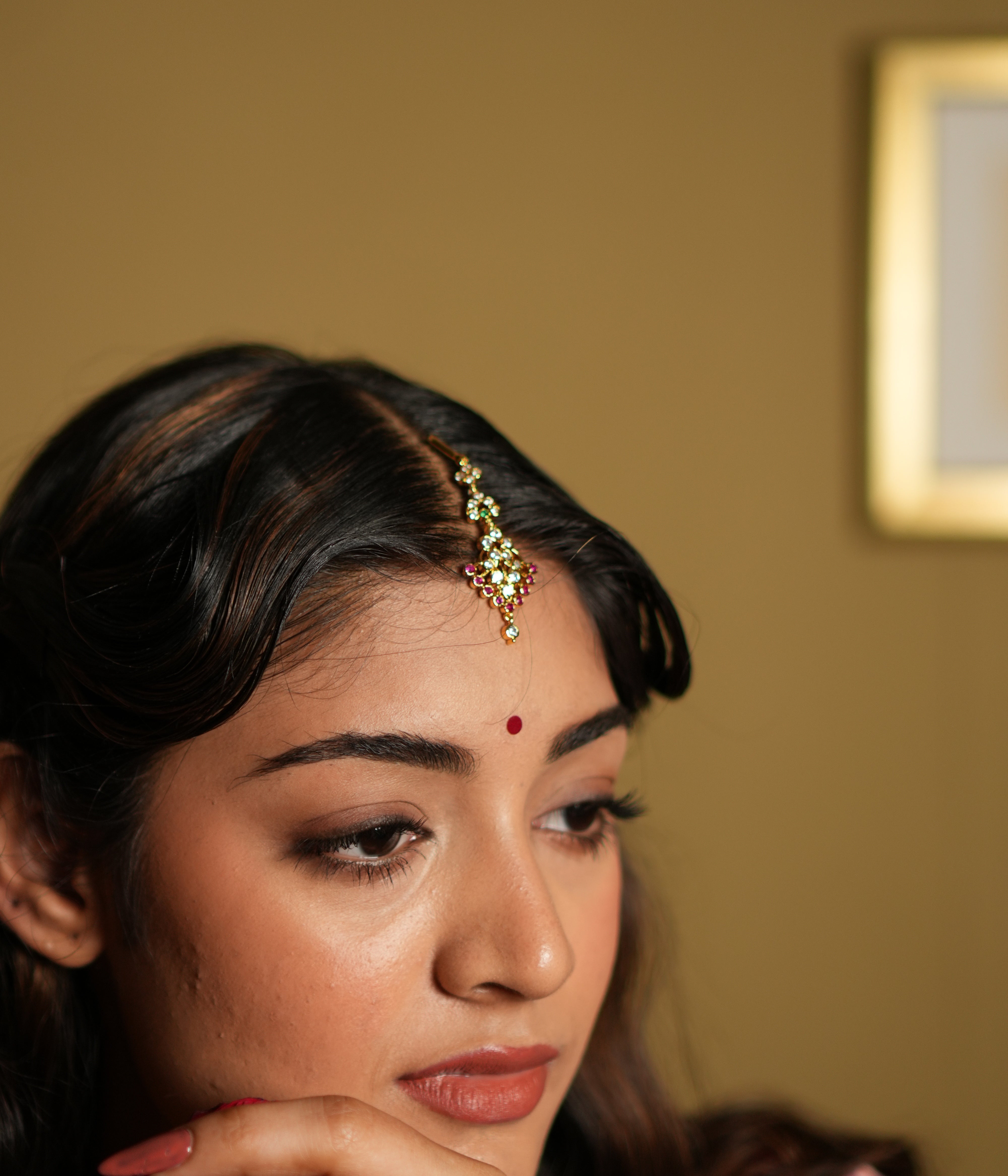  Maang Tikka, meticulously crafted from 92.5 sterling silver and finished with a rich 22-carat gold plating. The intricate design showcases a beautiful arrangement of vivid pink gemstones and sparkling white stones, creating a perfect balance of elegance and vibrancy. Ideal for weddings, festivals, and special occasions, this Maang Tikka gracefully enhances your forehead, adding a timeless charm to your look.