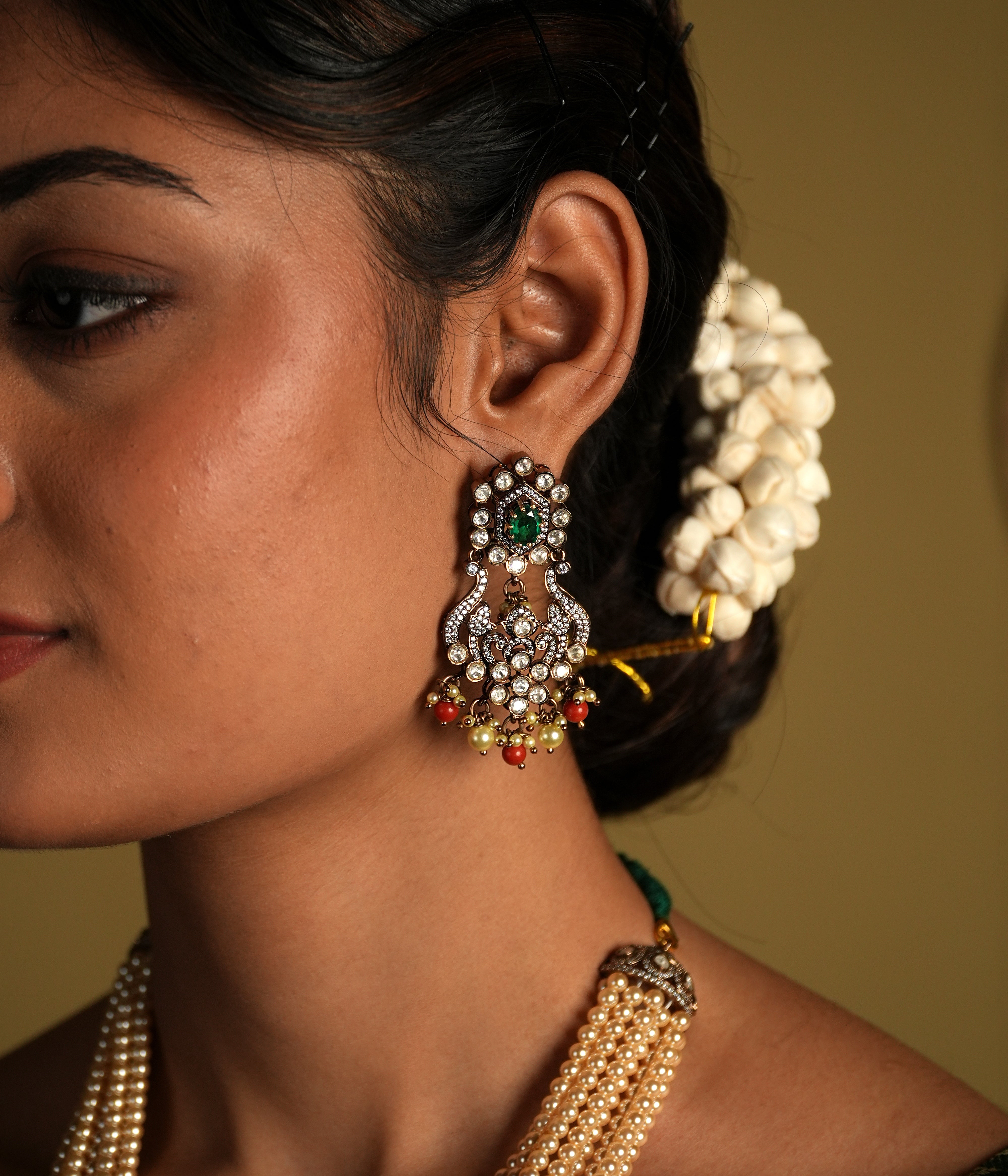 Crafted from 92.5 sterling silver, these exquisite gold-plated Victorian-style earrings feature intricate detailing with delicate floral motifs. Embellished with sparkling stones and colorful bead accents, they bring a regal charm to any traditional outfit. Perfect for weddings, festive occasions, or adding a statement to your ethnic wardrobe.