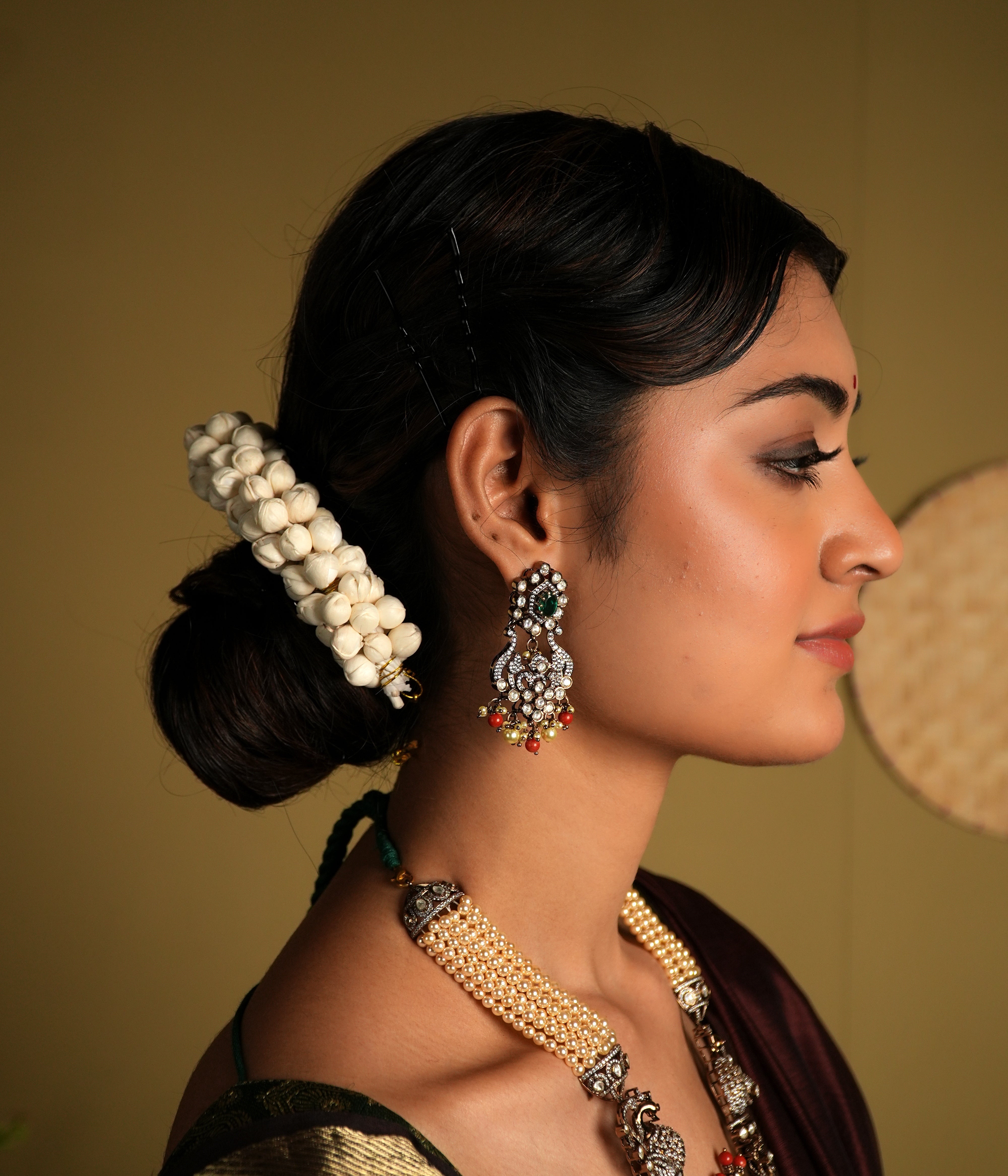 Crafted from 92.5 sterling silver, these exquisite gold-plated Victorian-style earrings feature intricate detailing with delicate floral motifs. Embellished with sparkling stones and colorful bead accents, they bring a regal charm to any traditional outfit. Perfect for weddings, festive occasions, or adding a statement to your ethnic wardrobe.