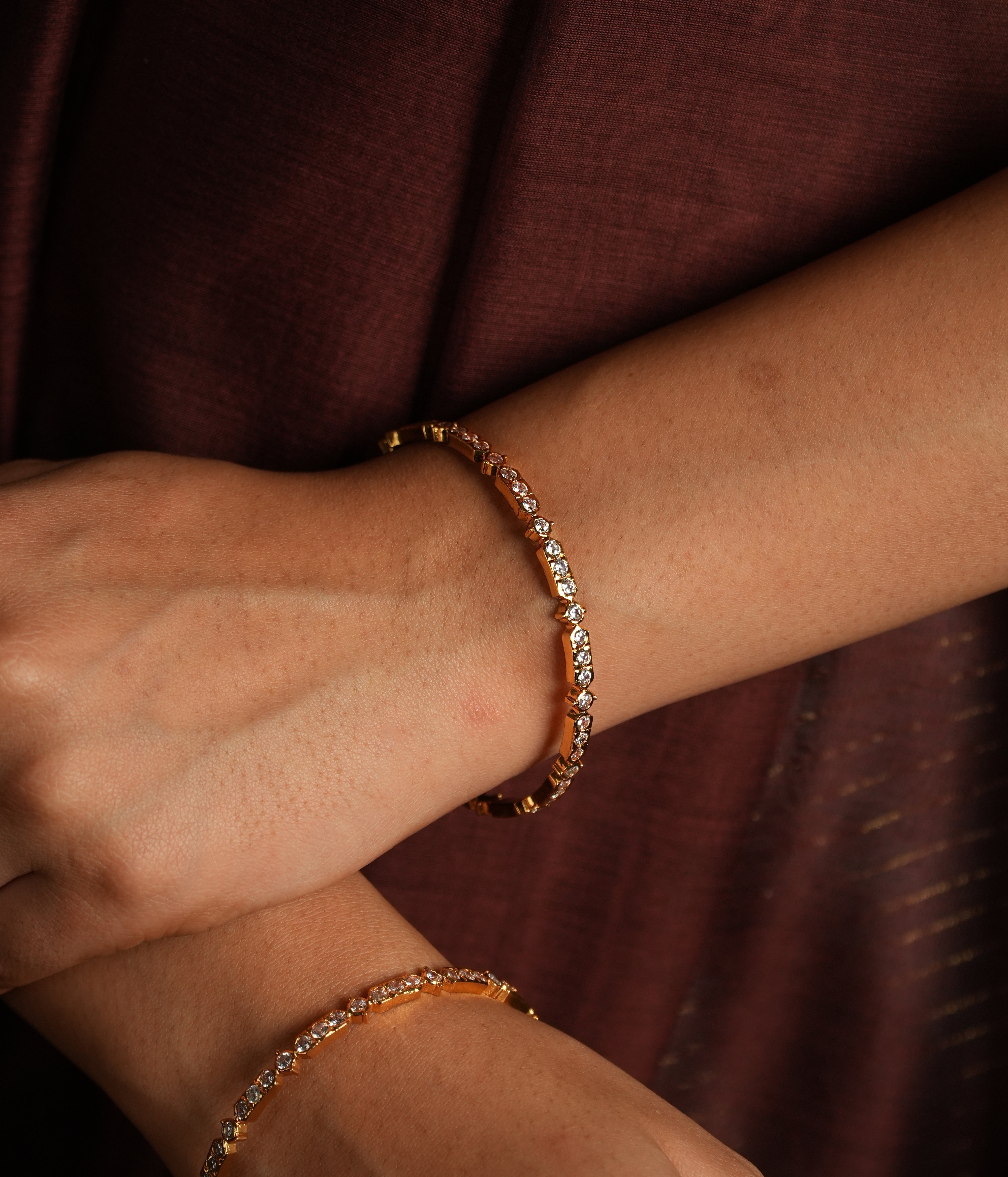 Capture the light with these stunning bangle bracelets, meticulously crafted with dazzling Swarovski crystals.  Each bangle showcases a delicate row of brilliantly faceted crystals, catching and reflecting light with every movement.