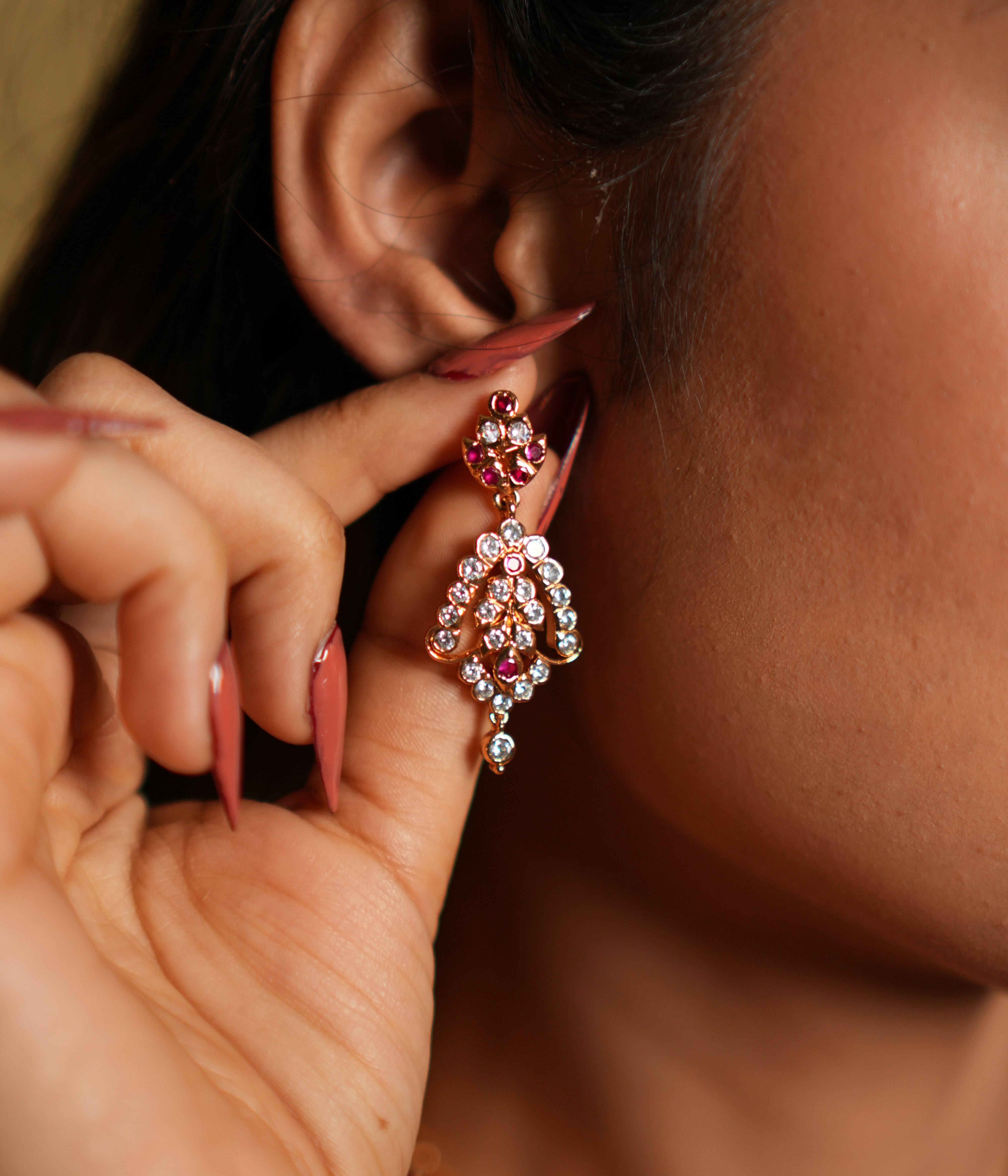  crafted from 92.5 sterling silver and finished with a luxurious 22-carat gold plating. The intricate design features a dazzling combination of brilliant swarovski stones and vibrant pink gemstones, creating a perfect balance of sparkle and color. Lightweight yet statement-worthy, these earrings are ideal for festive occasions, weddings, or adding a touch of glamour to any outfit. 