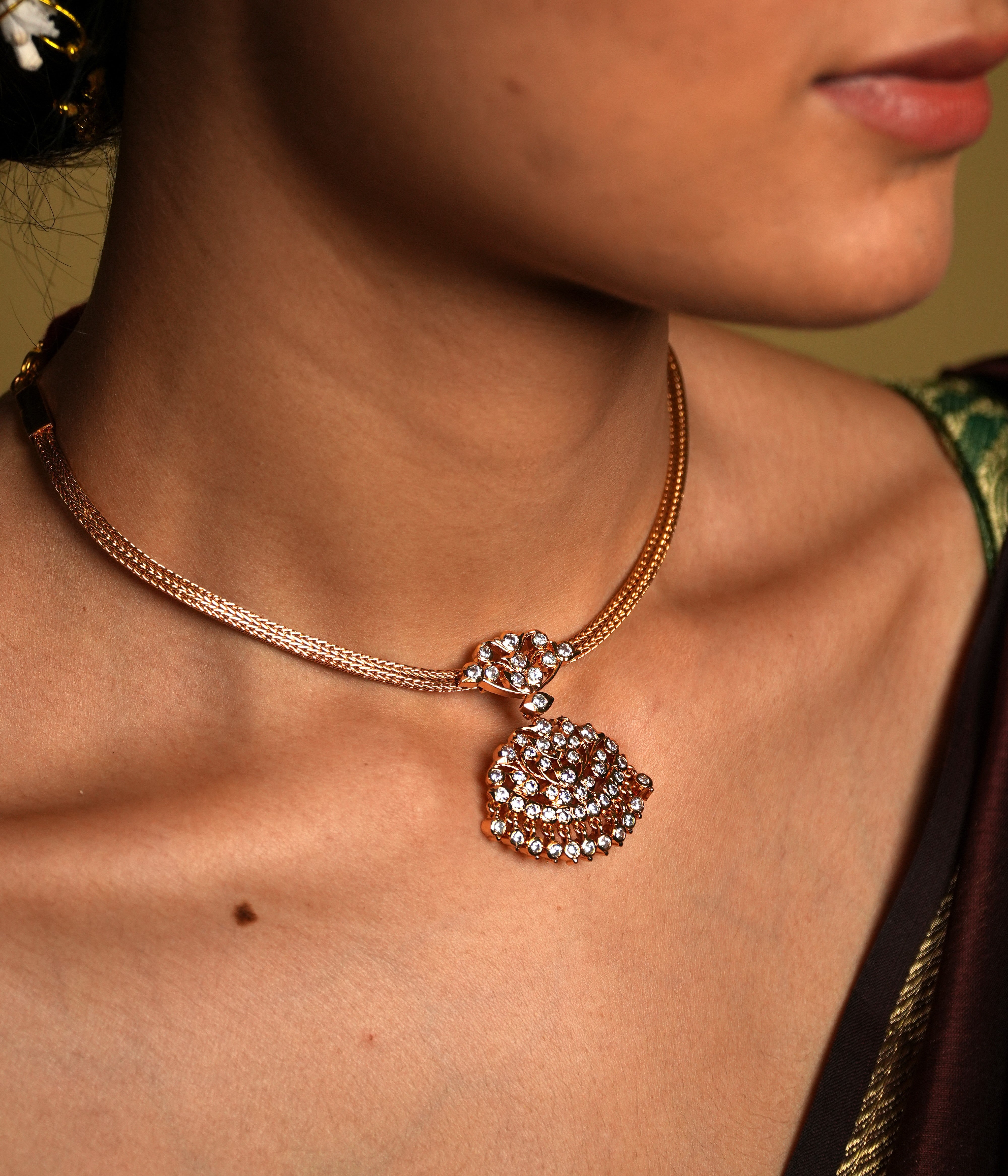 Crafted from high-quality 925 sterling silver and elegantly gold-plated, this choker features a traditional Chettinad pendant that embodies vintage sophistication. The gold plating gives the piece a luxurious glow, while the intricate details of the pendant reflect the rich heritage of Chettinad craftsmanship.