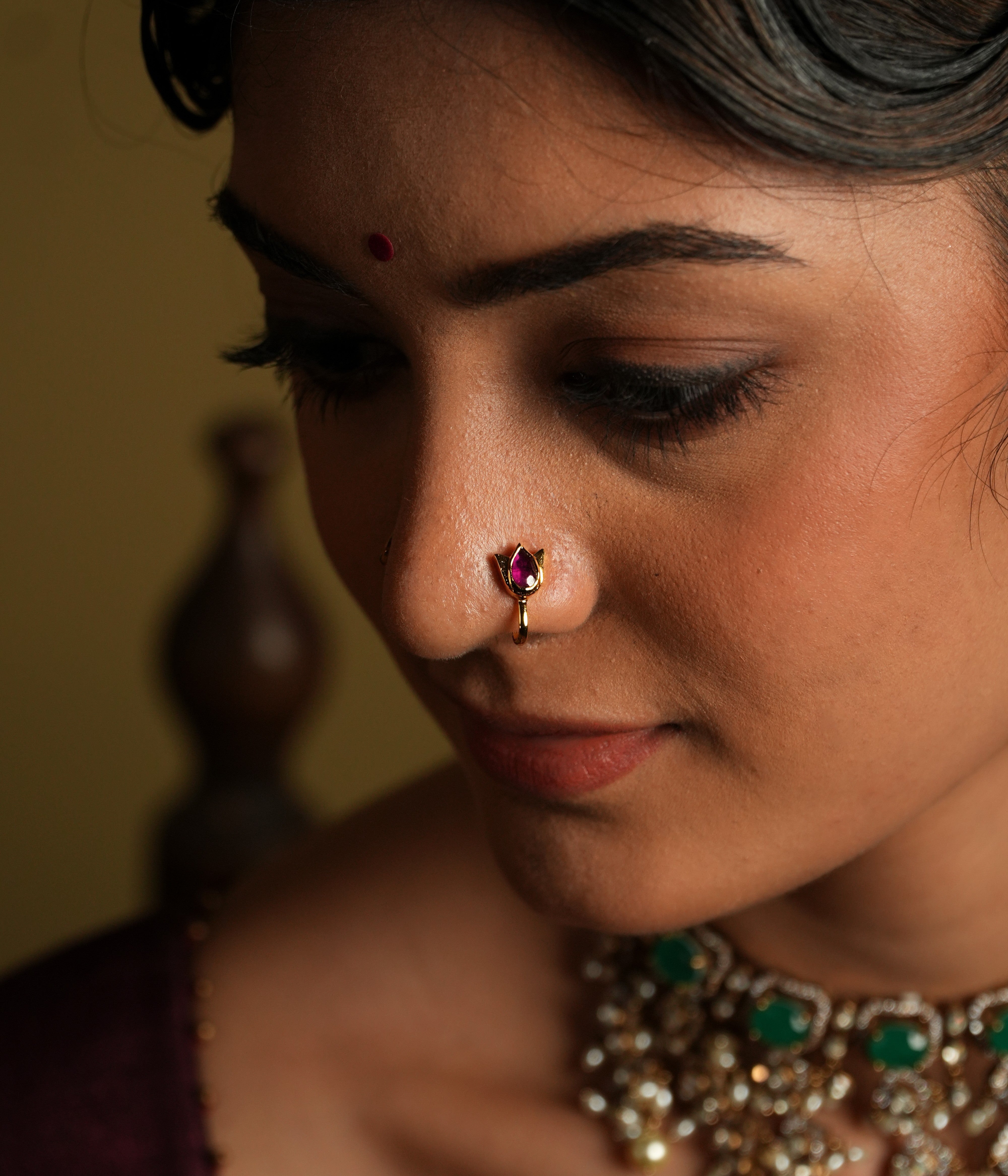 Accented with a delicate pink Kundan center, it adds a soft pop of color and radiance. Crafted from 925 silver, this nose stud offers a refined yet understated design that beautifully captures the essence of nature’s purity and beauty.