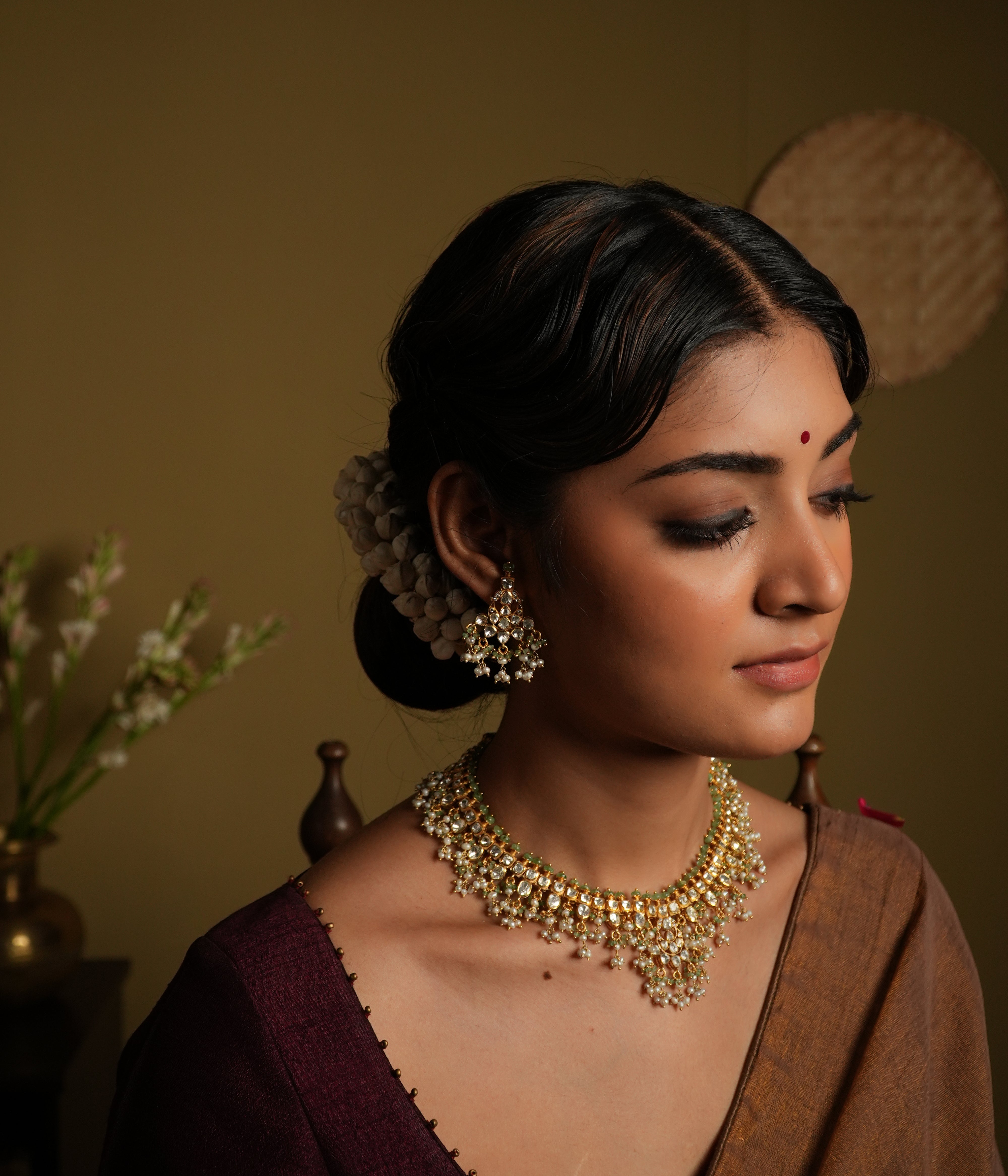 Elevate your traditional look with this exquisite silver gold-plated jewelry set, featuring a Kundan choker necklace and matching chandelier earrings.