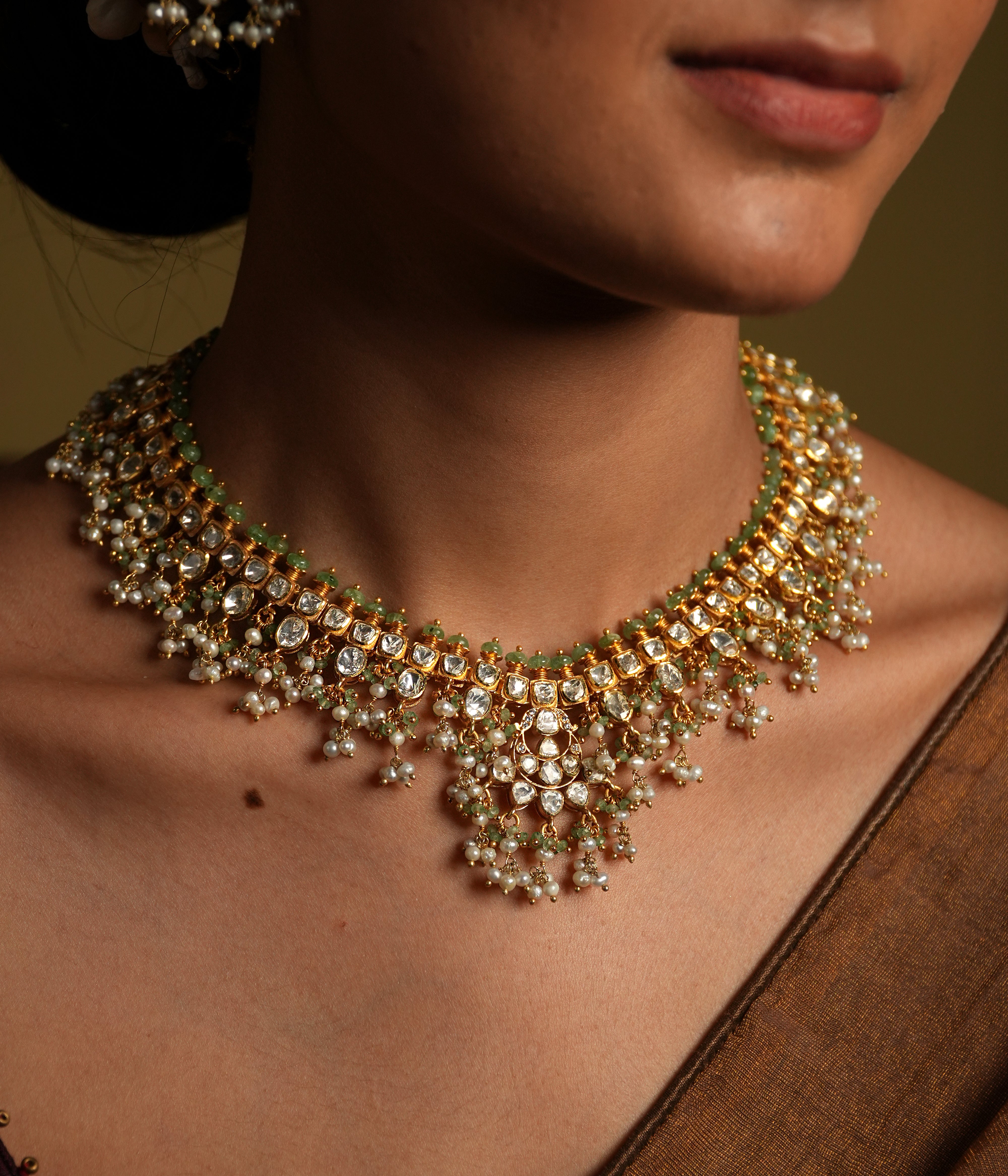 Elevate your traditional look with this exquisite silver gold-plated jewelry set, featuring a Kundan choker necklace and matching chandelier earrings.