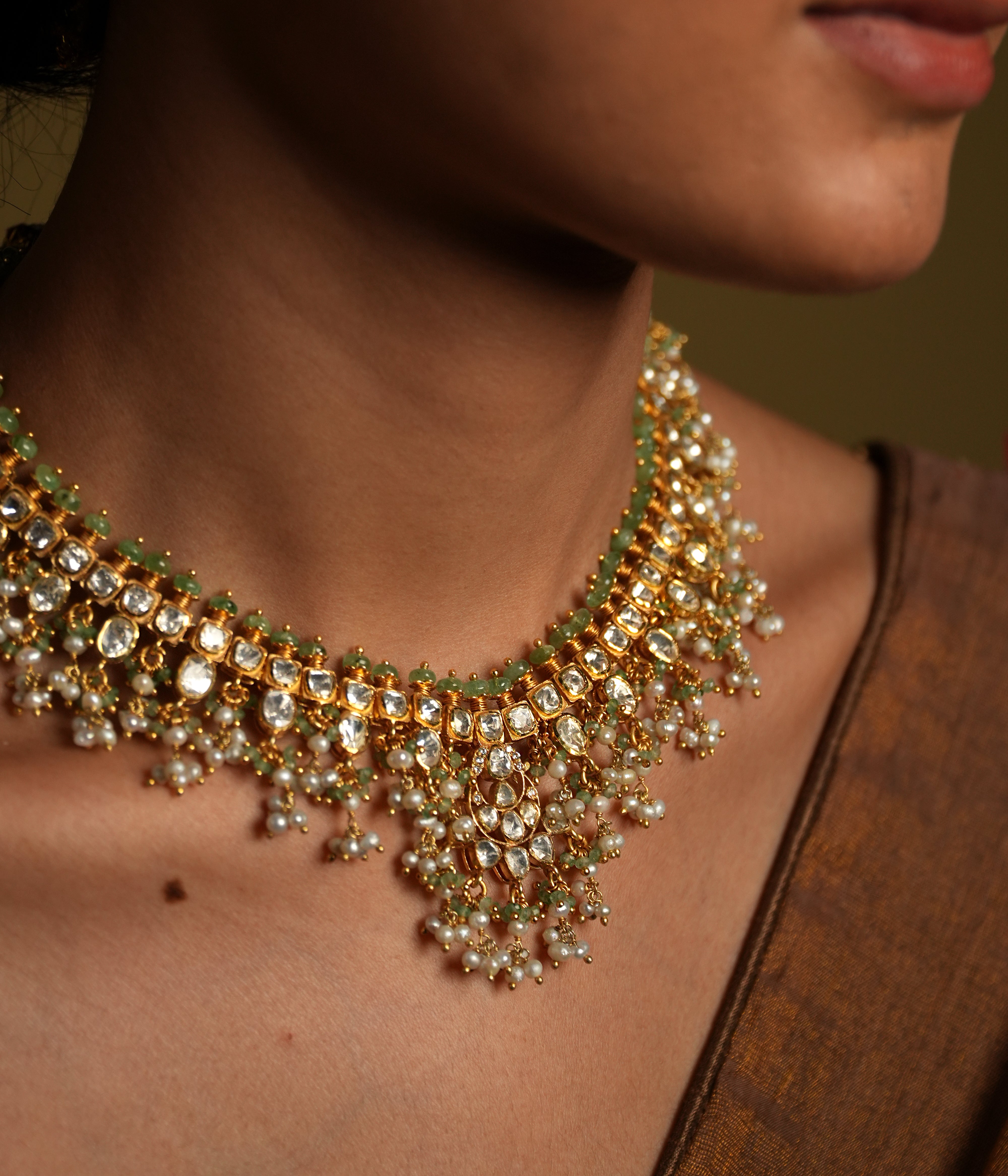 Elevate your traditional look with this exquisite silver gold-plated jewelry set, featuring a Kundan choker necklace and matching chandelier earrings.