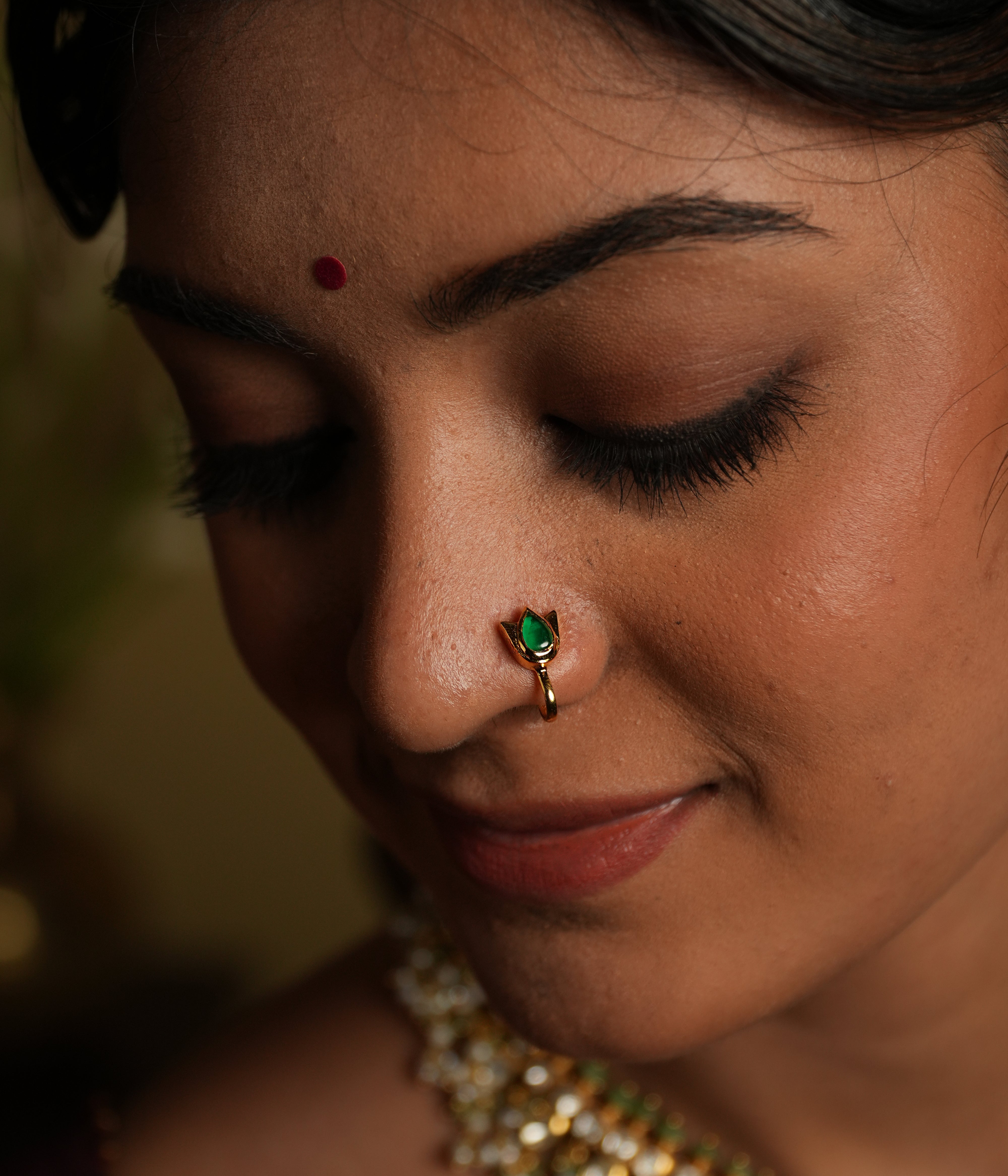 Enhance your beauty with this exquisite nose pin, featuring a mesmerizing spinel stone set in a delicate silver gold-plated frame. Designed for effortless elegance, this timeless piece showcases a pear-cut green spinel, symbolizing grace and sophistication.