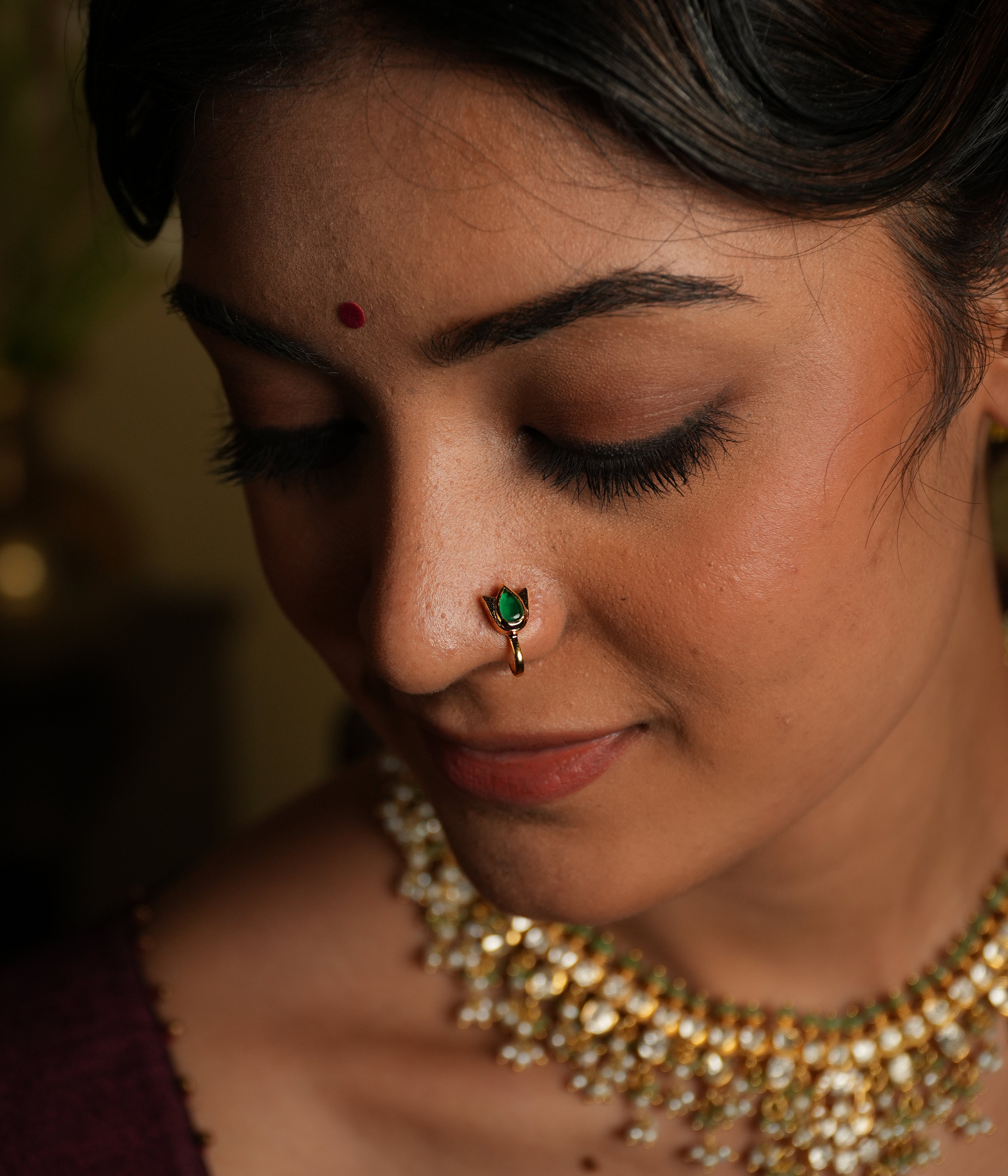 Enhance your beauty with this exquisite nose pin, featuring a mesmerizing spinel stone set in a delicate silver gold-plated frame. Designed for effortless elegance, this timeless piece showcases a pear-cut green spinel, symbolizing grace and sophistication.