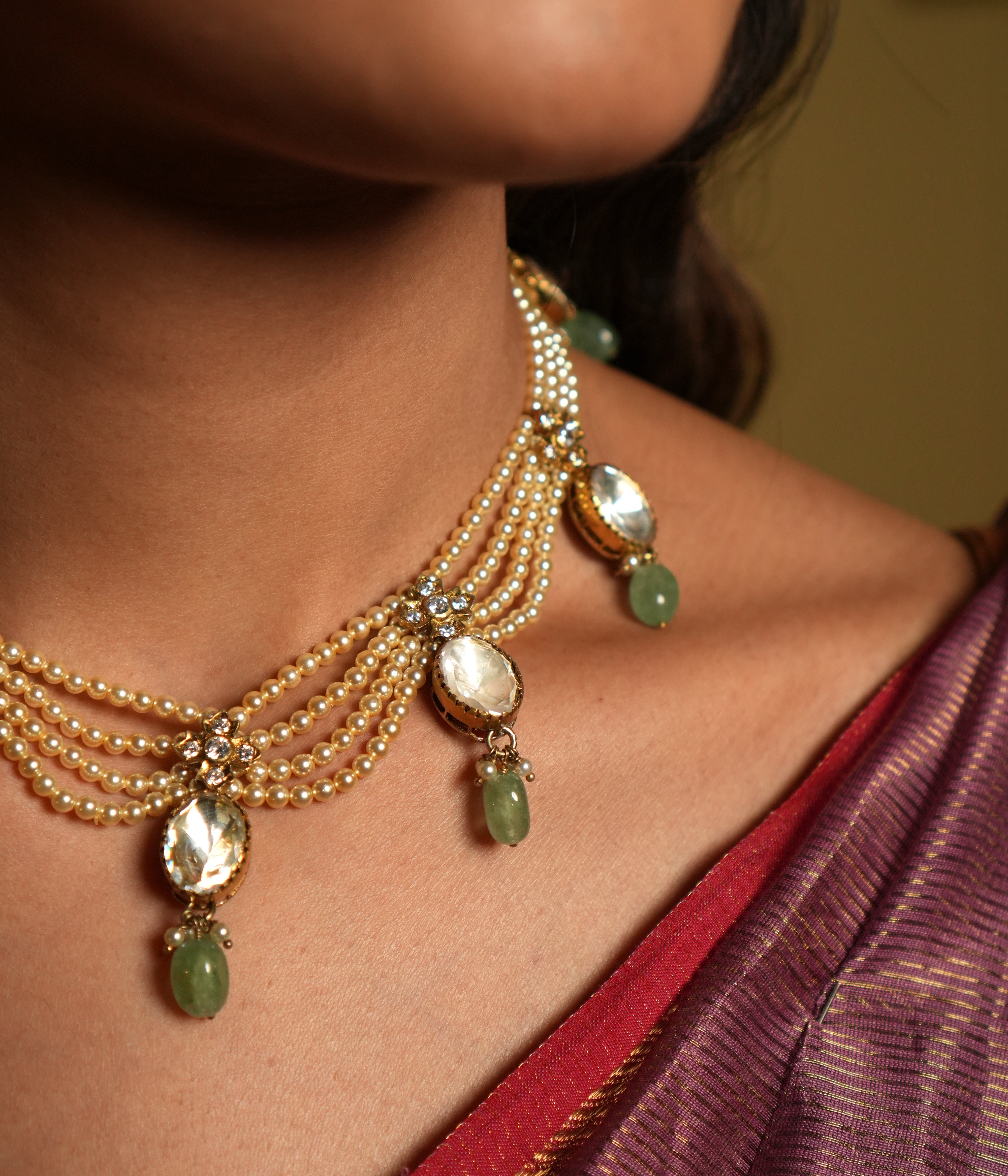 Elevate your traditional attire with this exquisite Moissanite Necklace Set, crafted from 92.5 sterling silver and finished with a rich 22-carat gold plating. The necklace features radiant moissanite stones paired with delicate green gemstone drops, adding a refreshing touch of color and elegance.