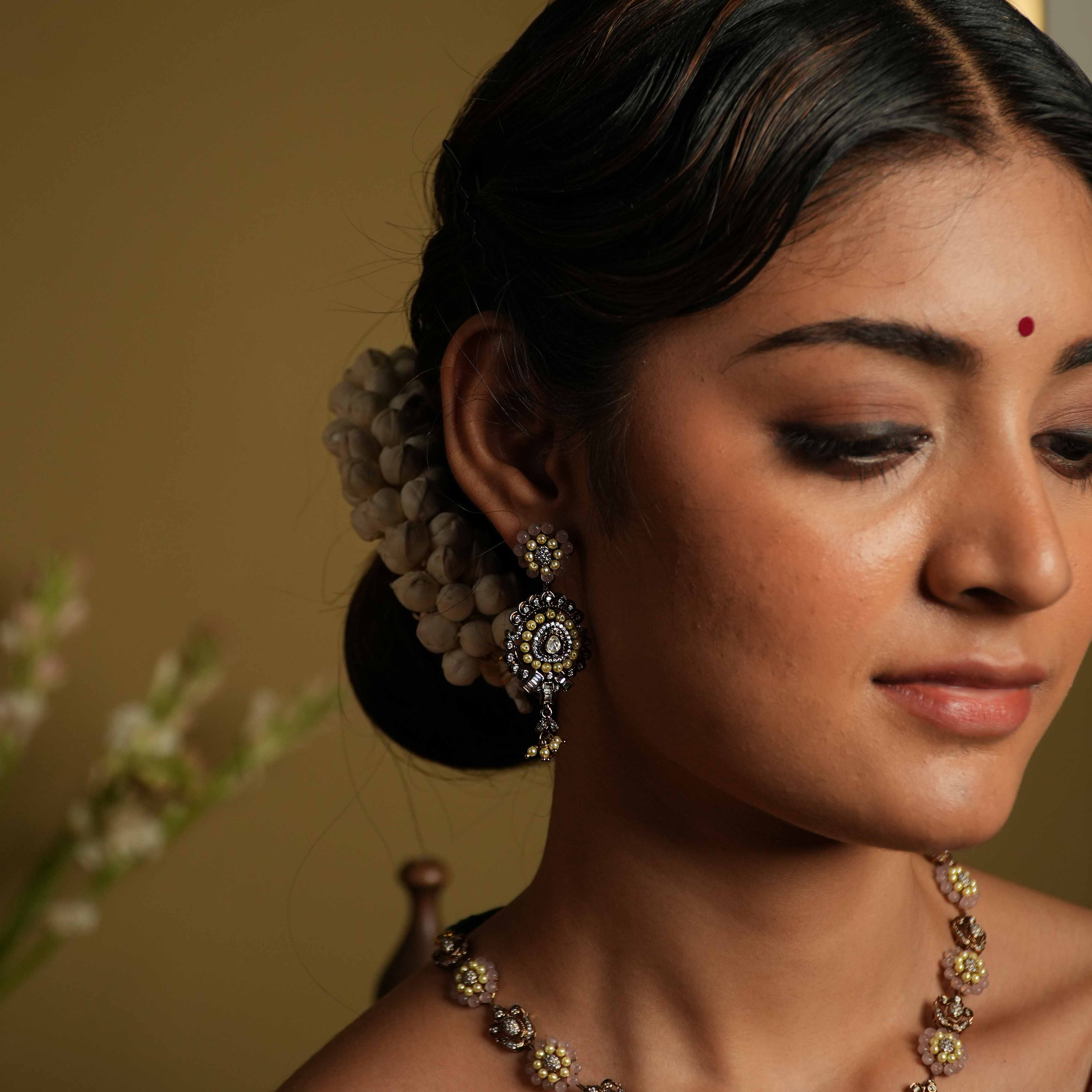 Antique silver earrings crafted from 92.5 sterling silver, featuring lines of lustrous pearls and semi-precious gemstone florals, with a bold teardrop dangle, exuding vintage romance and whimsical charm.