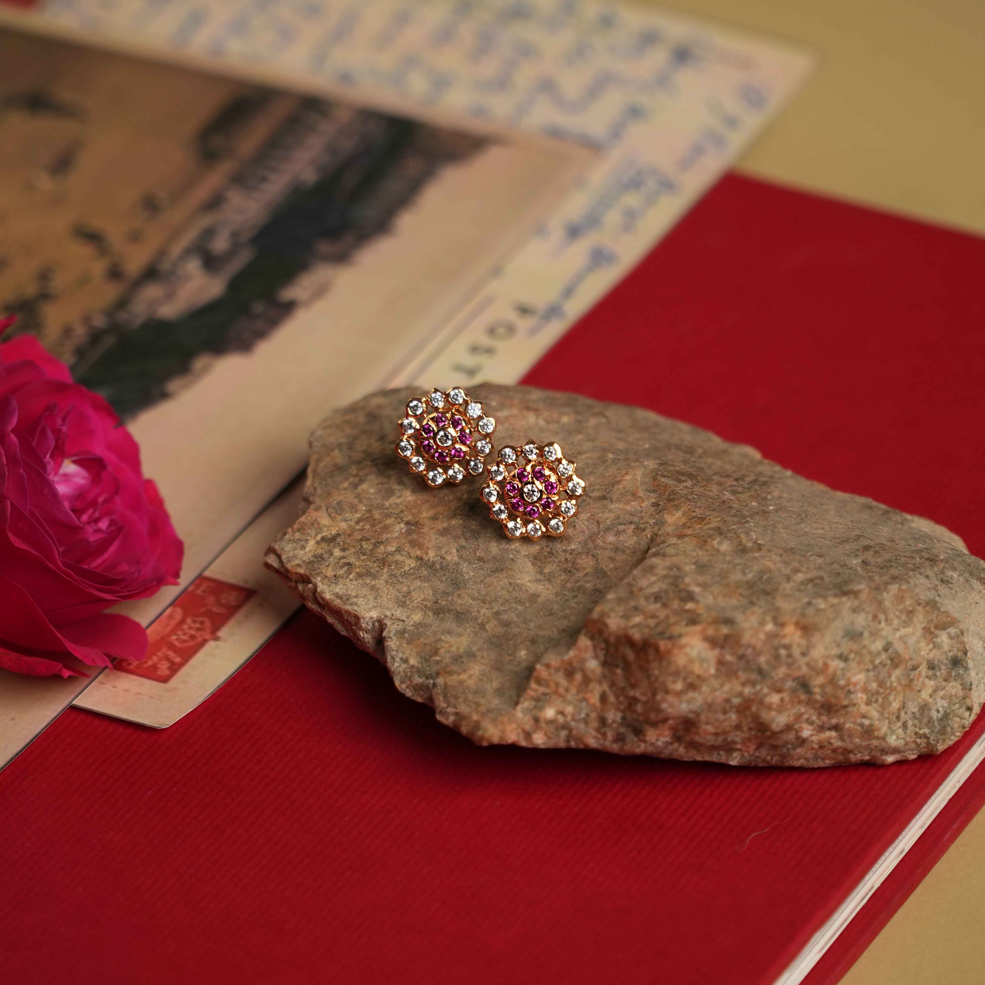 The Hasumathi Ear Stud: Minimalist 92.5 sterling silver ear studs with South screw fastening, featuring Swarovski crystals and red gemstone accents, inspired by the revered stone settings of Chettinad.