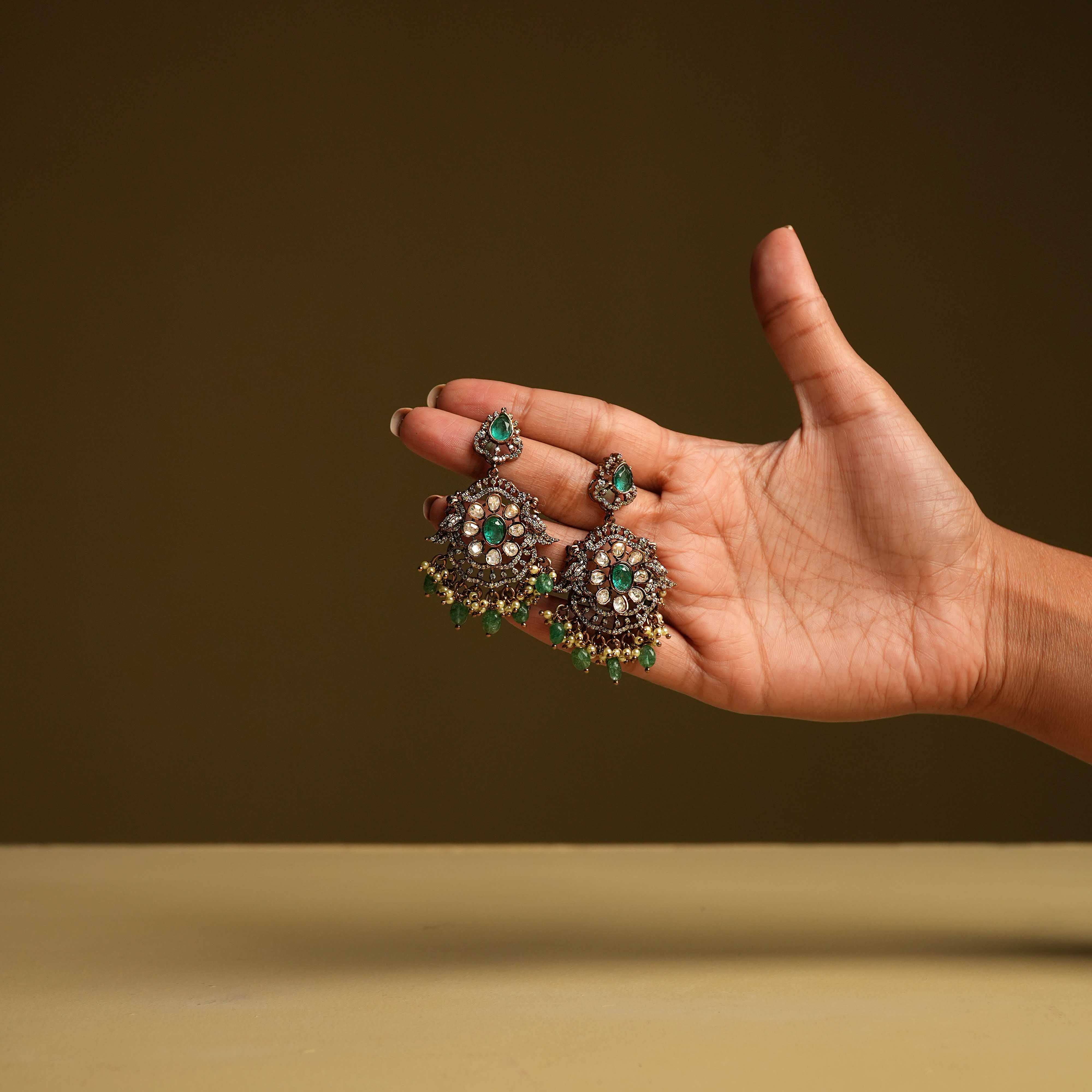 Royal Chandbali earrings, handcrafted from 92.5 sterling silver with 14ct dark antique gold plating and screw-type fastenings, featuring polki stones, CZ stones, green gemstones, and polki stones, with cultured emerald and pearl danglings evoking the opulence of a bygone era.