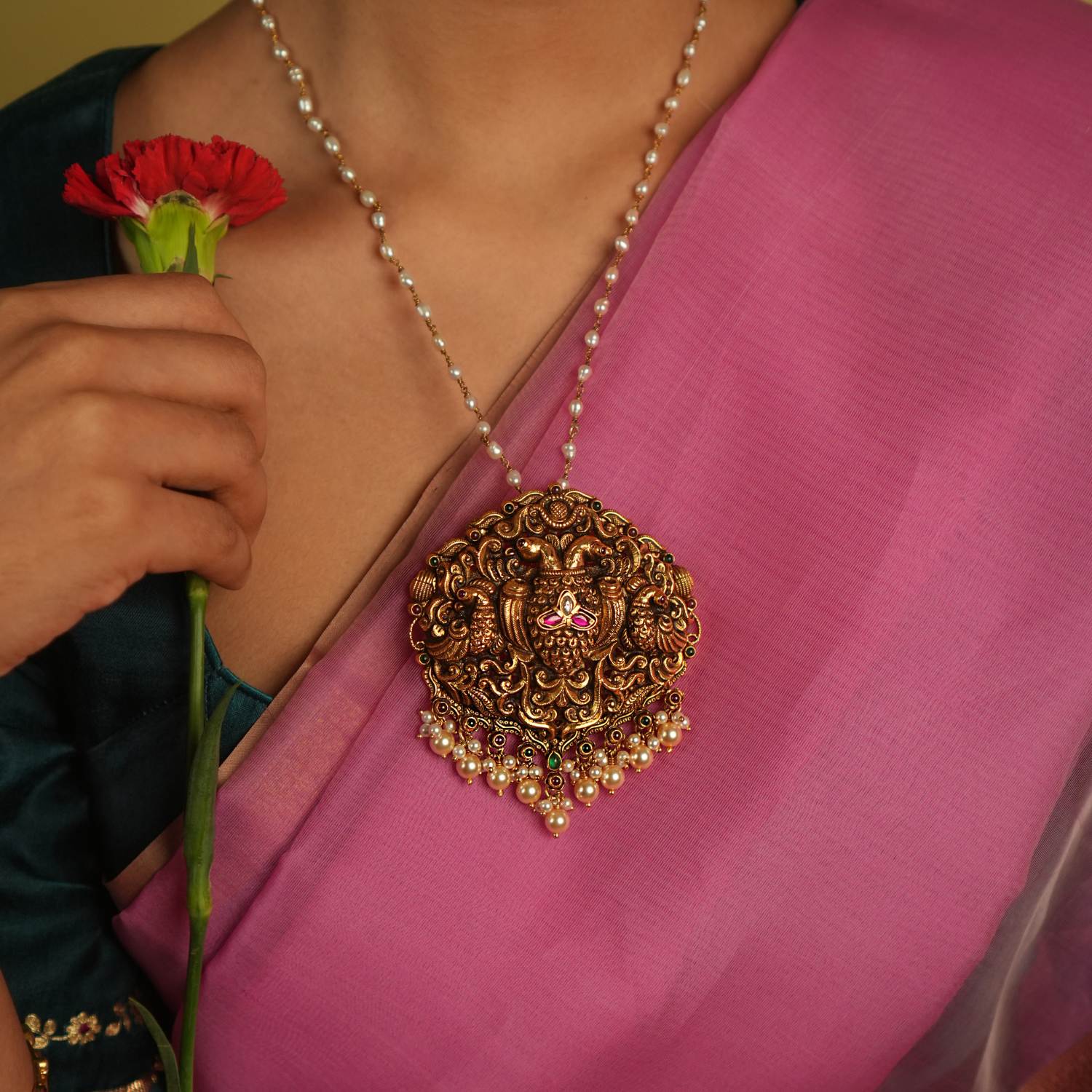 Adorn yourself with timeless elegance through our exquisite handcrafted pendant, featuring red and white Kundan stones, along with red and green spinel stones. Perfectly designed for traditional occasions, this pendant adds a touch of grace and sophistication to your ensemble.