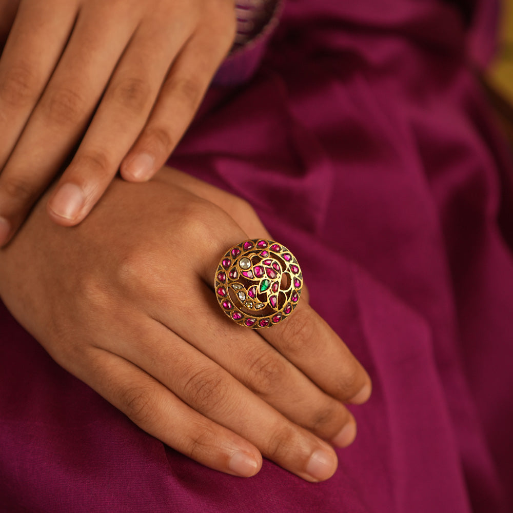 Majestic plumage reborn! This Kundan peacock ring dazzles with red, green, and white stones, echoing timeless grace and regal charm.