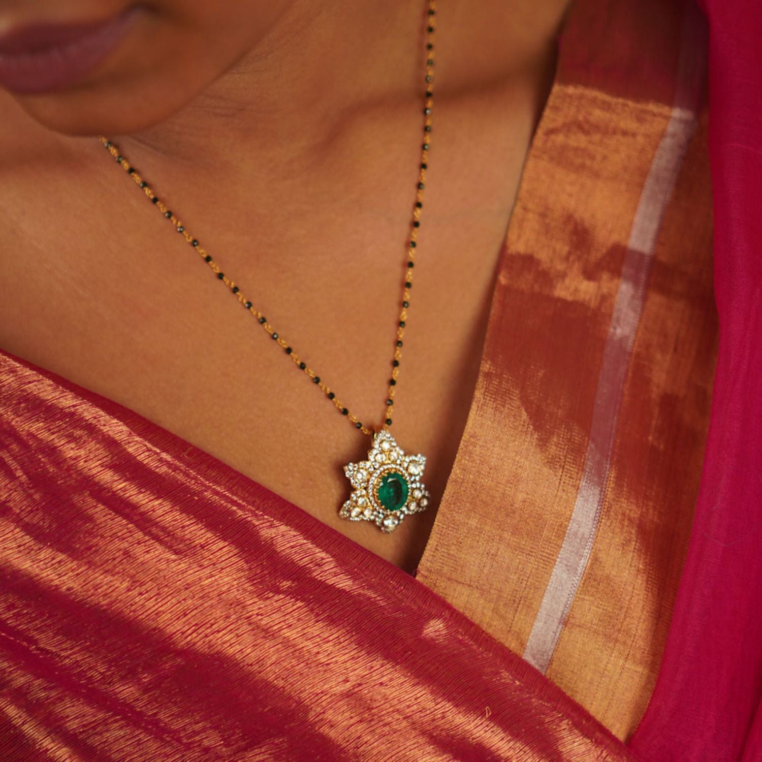 Handcrafted in gold-plated silver, the Chemmoli Mangalsutra showcases a star-shaped pendant adorned with a radiant green gemstone, shimmering polki stones, and CZ accents—a timeless symbol of elegance and grace.