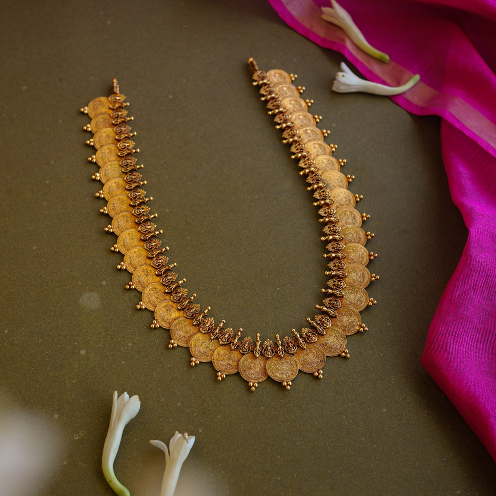 Antique gold temple necklace with dual-layer goddess coin motifs and intricate bead detailing.